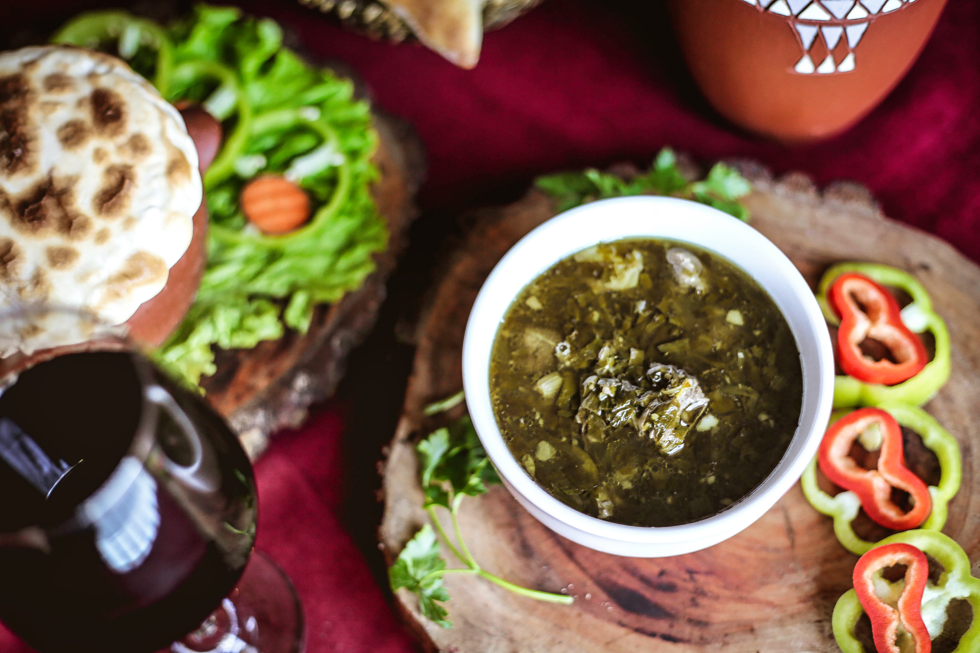 Overhead flat-lay of all ingredients for Cumin-Scented Afghan Khameerbob with Herbal Mint Sauce laid out on a kitchen surface.