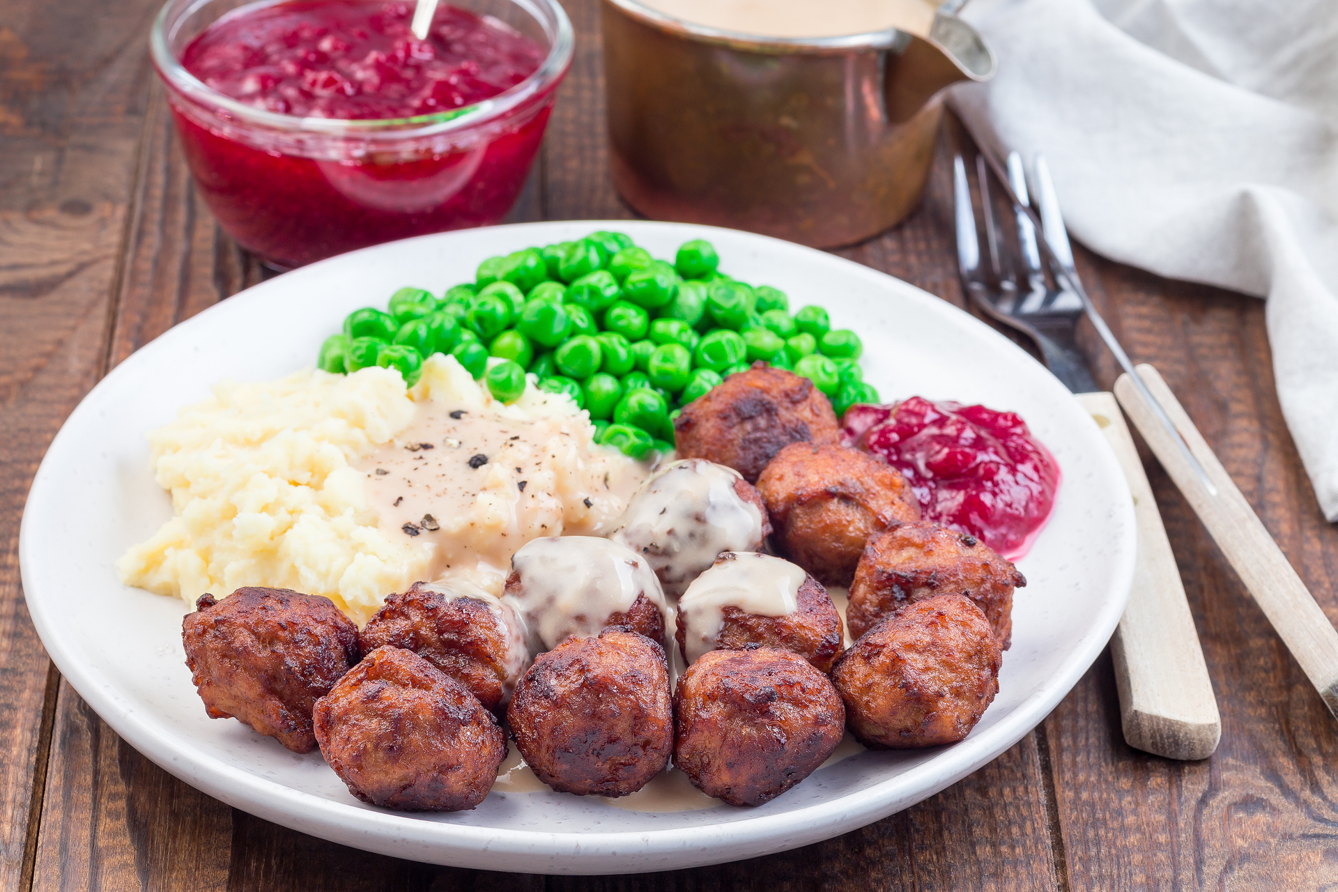 Overhead flat-lay of all ingredients for Danish Frikadeller with Parsley and Gravy laid out on a kitchen surface.