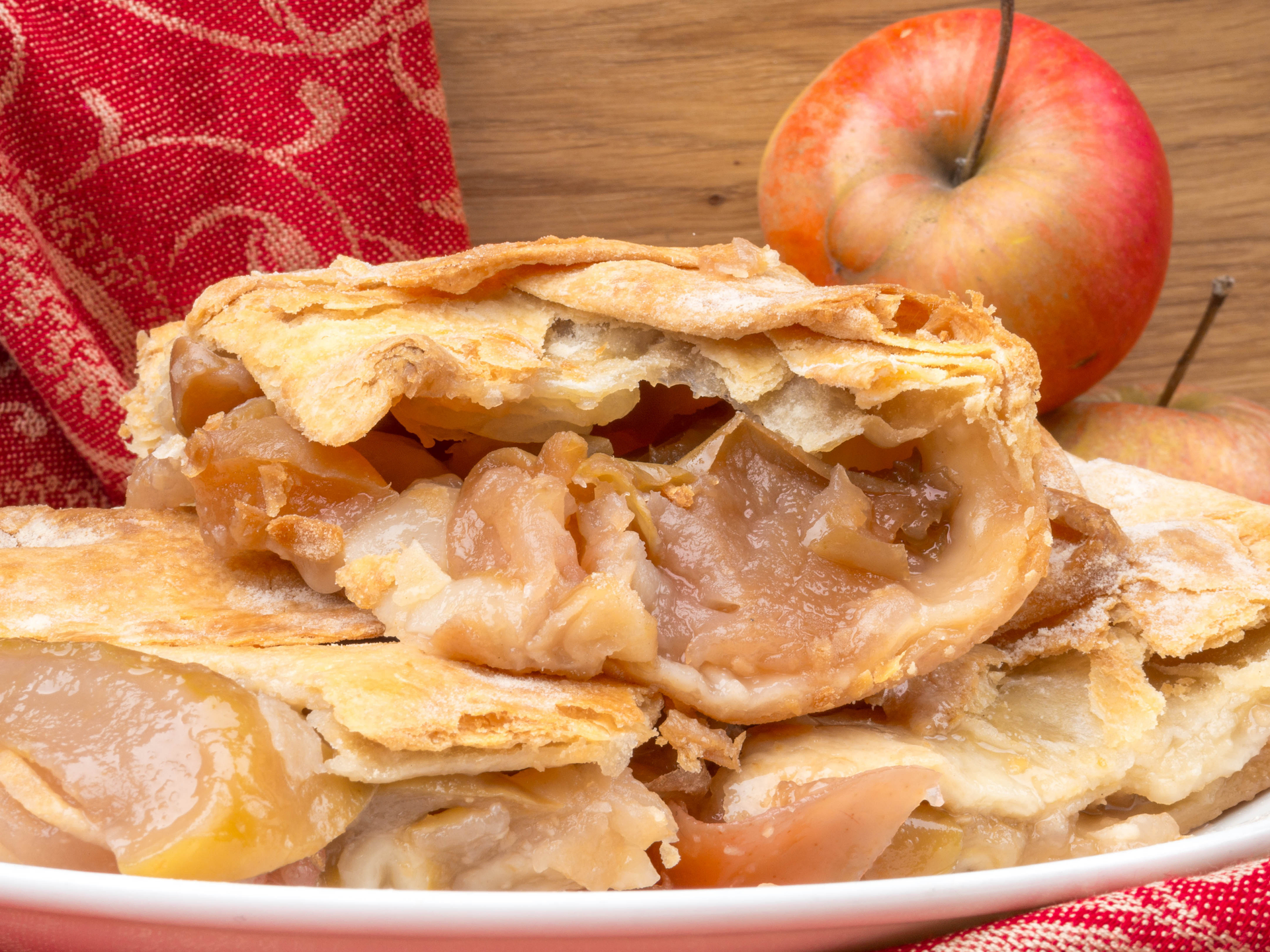 Overhead flat-lay of all ingredients for Decadent Apple Rose Puff Pastry with Spiced Maple Glaze laid out on a kitchen surface.
