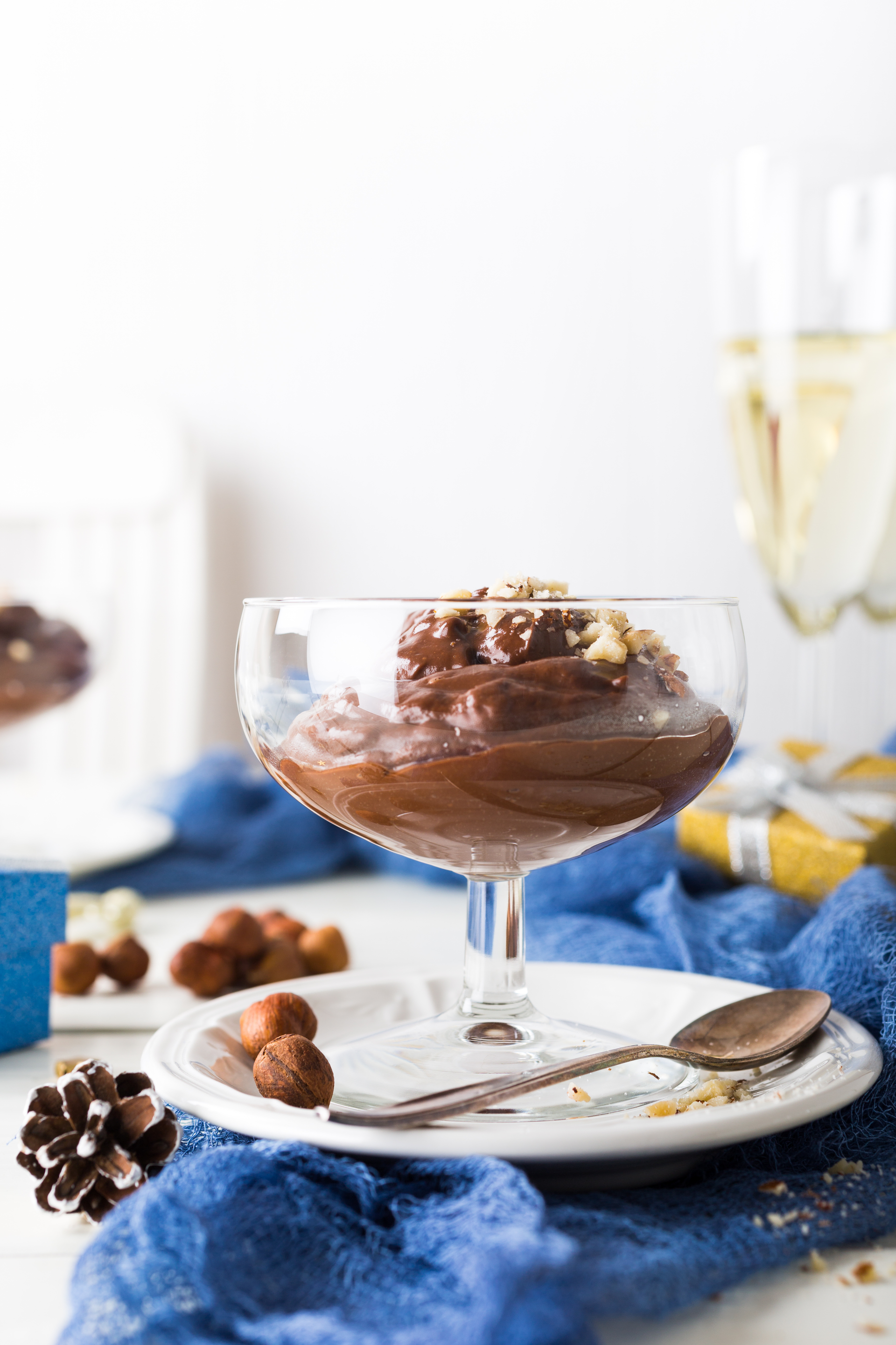 Overhead flat-lay of all ingredients for Decadent Belgian Chocolate Mousse with Hazelnut Praline laid out on a kitchen surface.