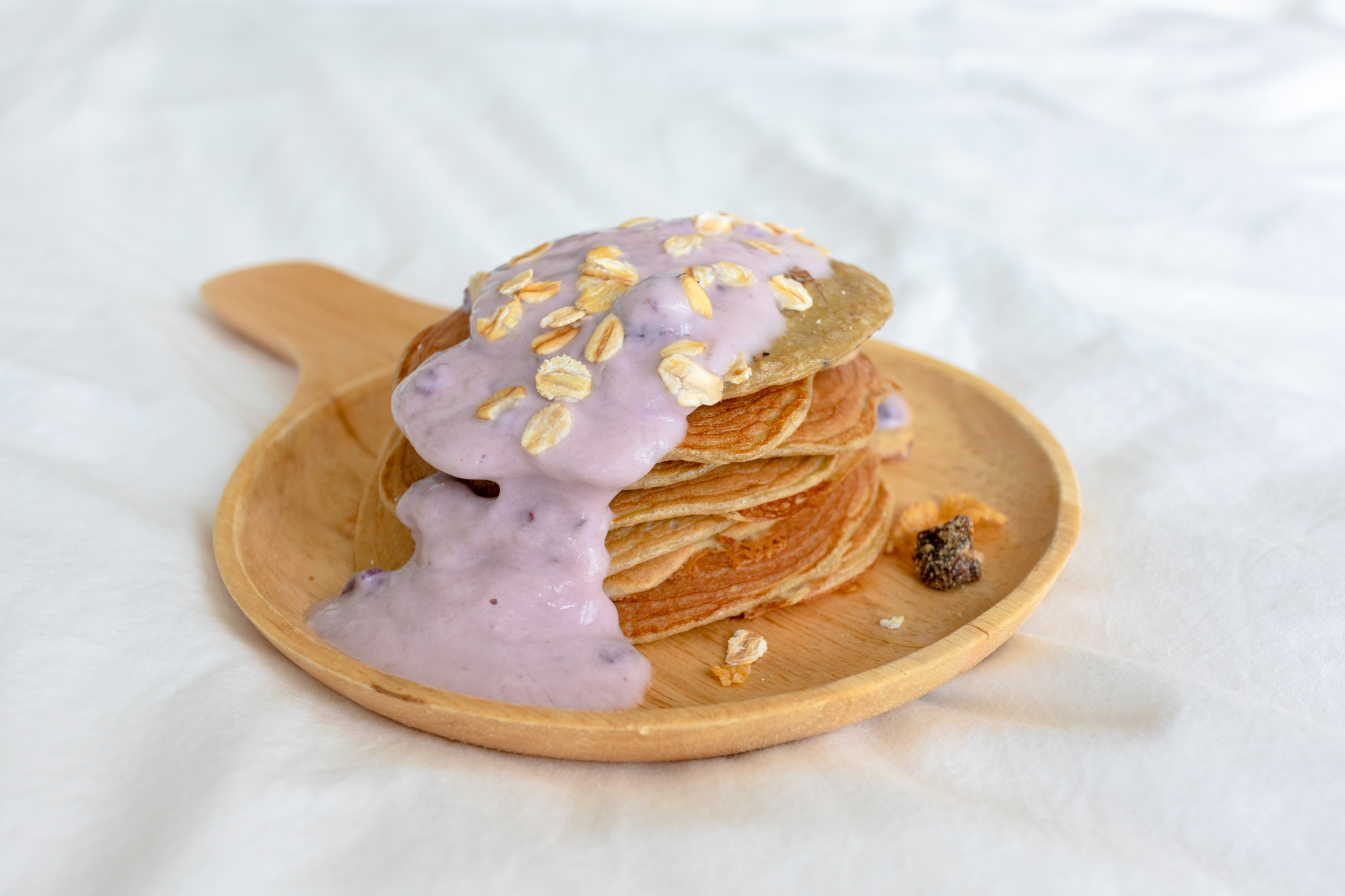Overhead flat-lay of all ingredients for Delicate Filipino Ube Pancakes with Coconut Syrup laid out on a kitchen surface.