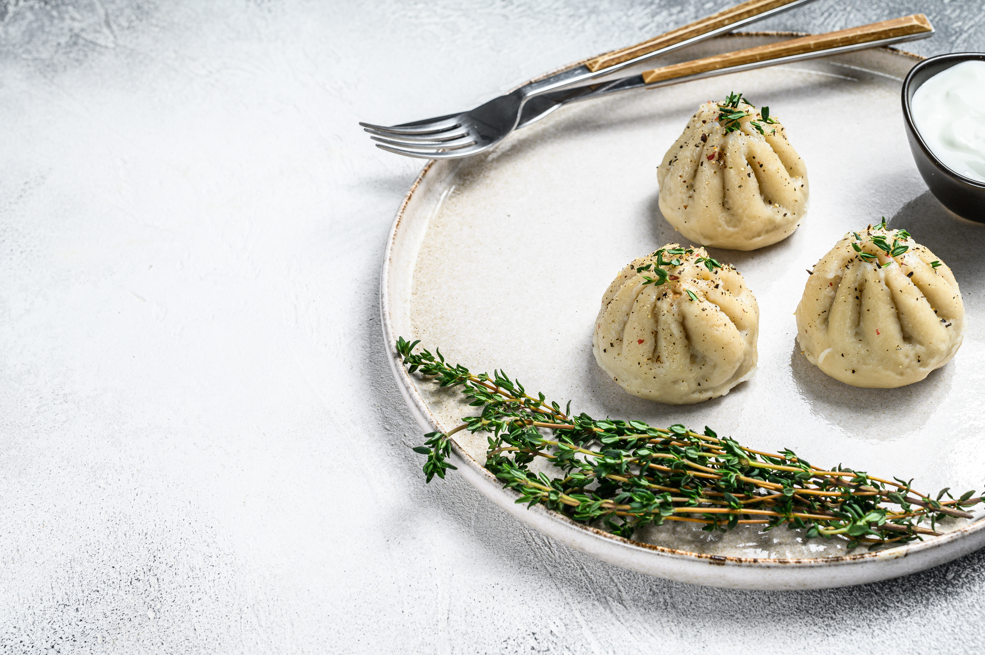 Overhead flat-lay of all ingredients for Delicate Georgian Khinkali with Caraway and Dill laid out on a kitchen surface.