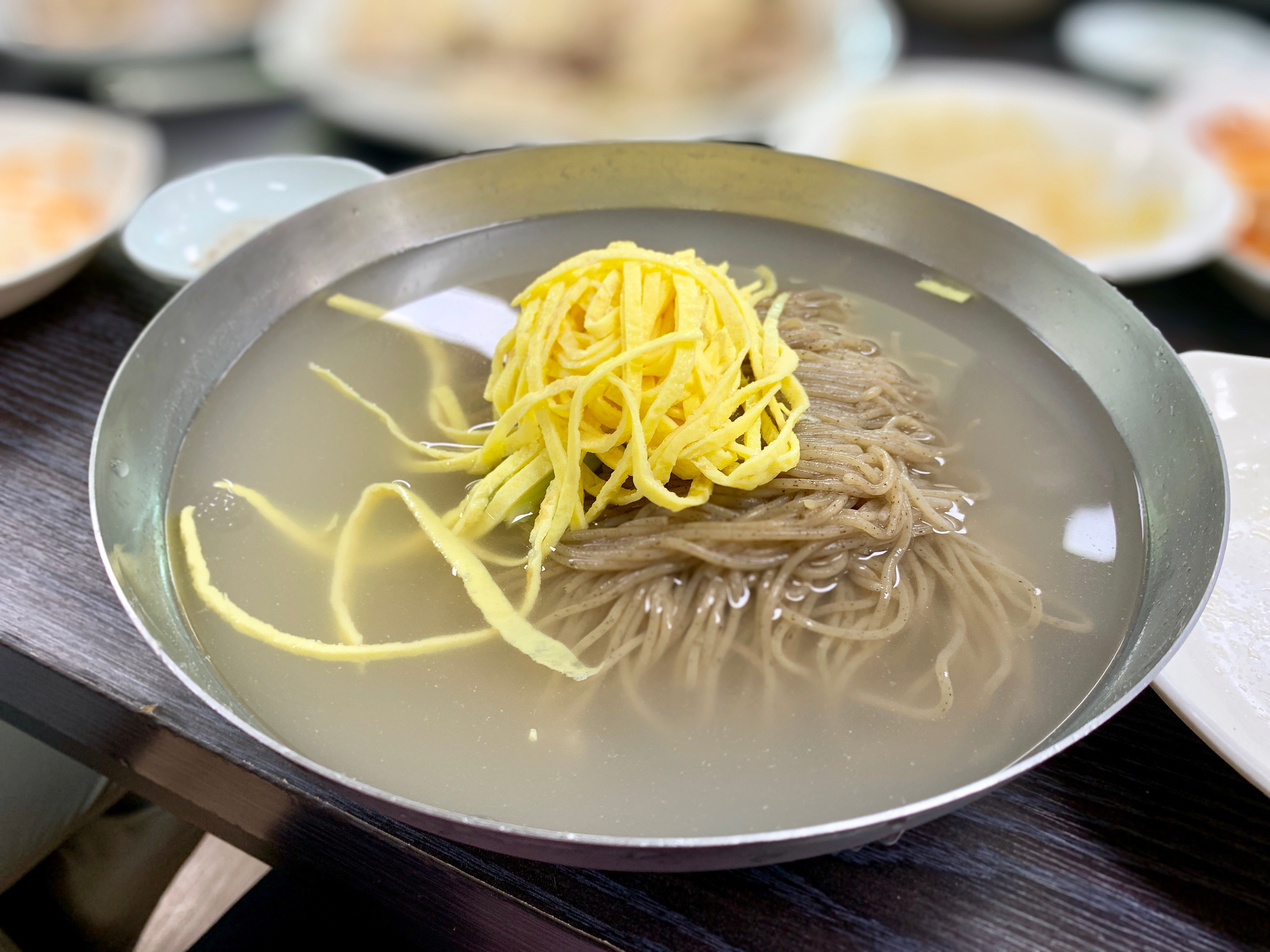 Overhead flat-lay of all ingredients for Delicate Japanese Udon Noodles with Yuzu Kosho Broth laid out on a kitchen surface.