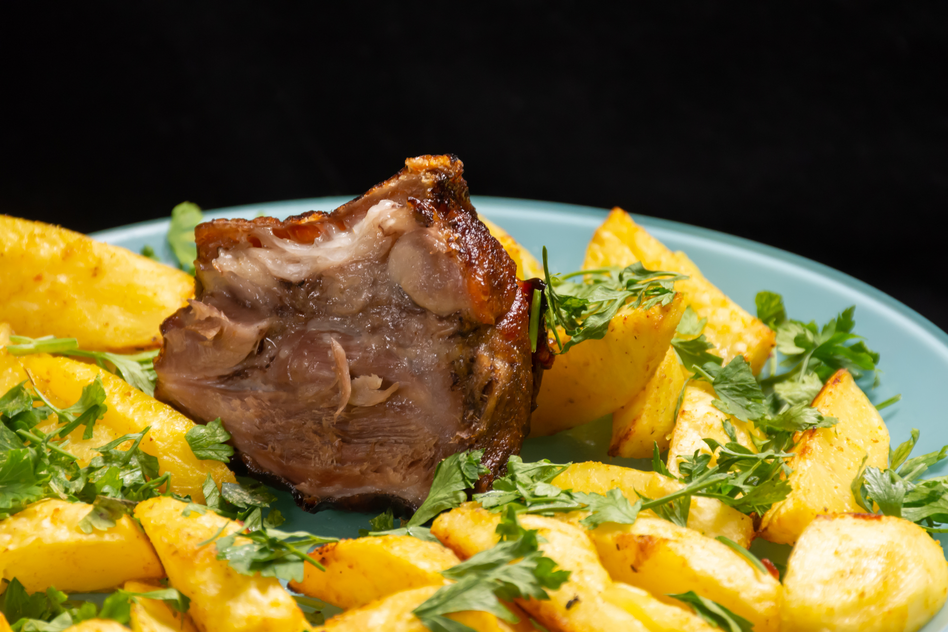 Duck Confit with Pommes Sarladaise — Main Course served and photographed from above