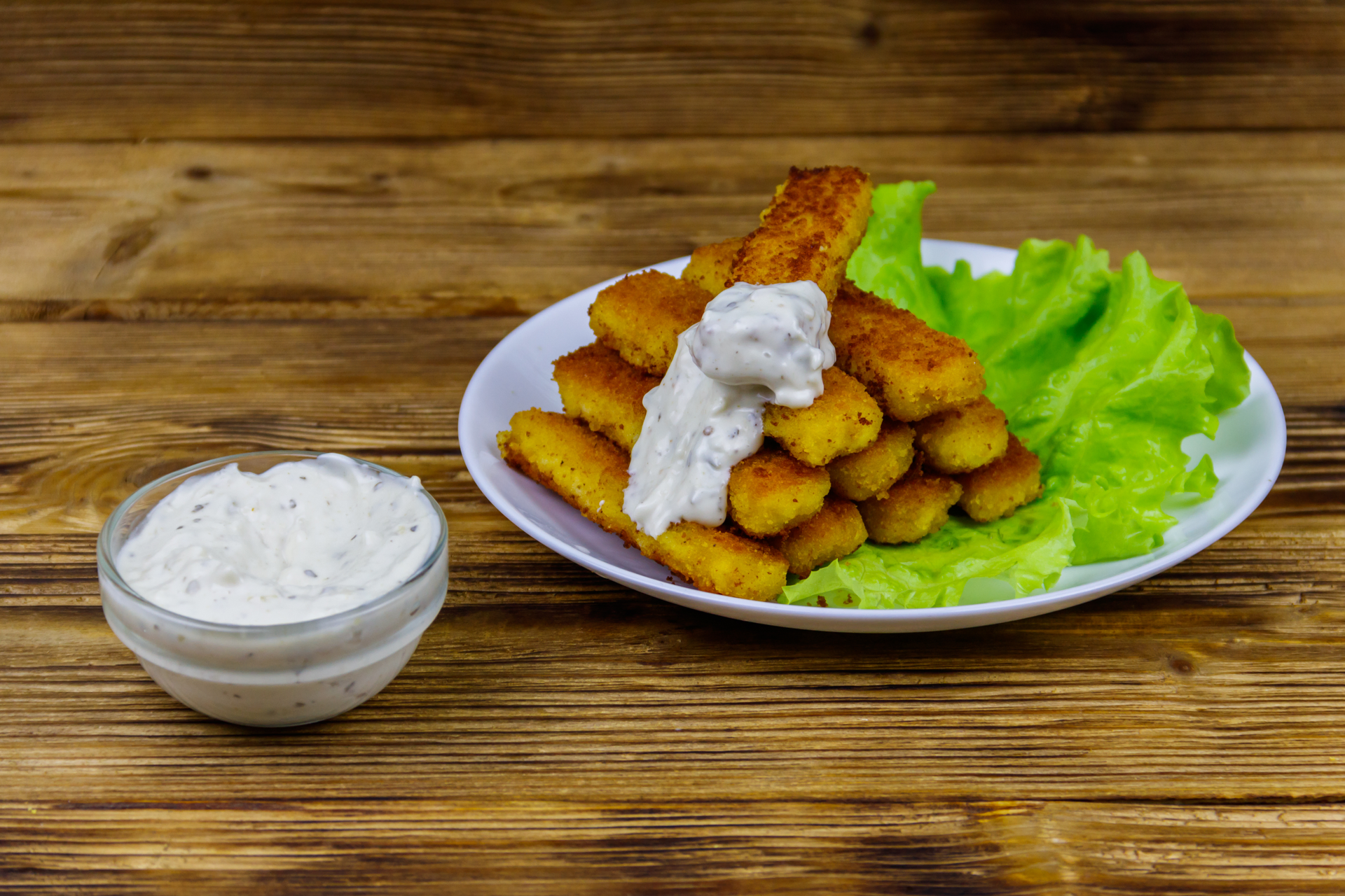 Overhead flat-lay of all ingredients for Dutch Kibbeling with Remoulade Sauce laid out on a kitchen surface.