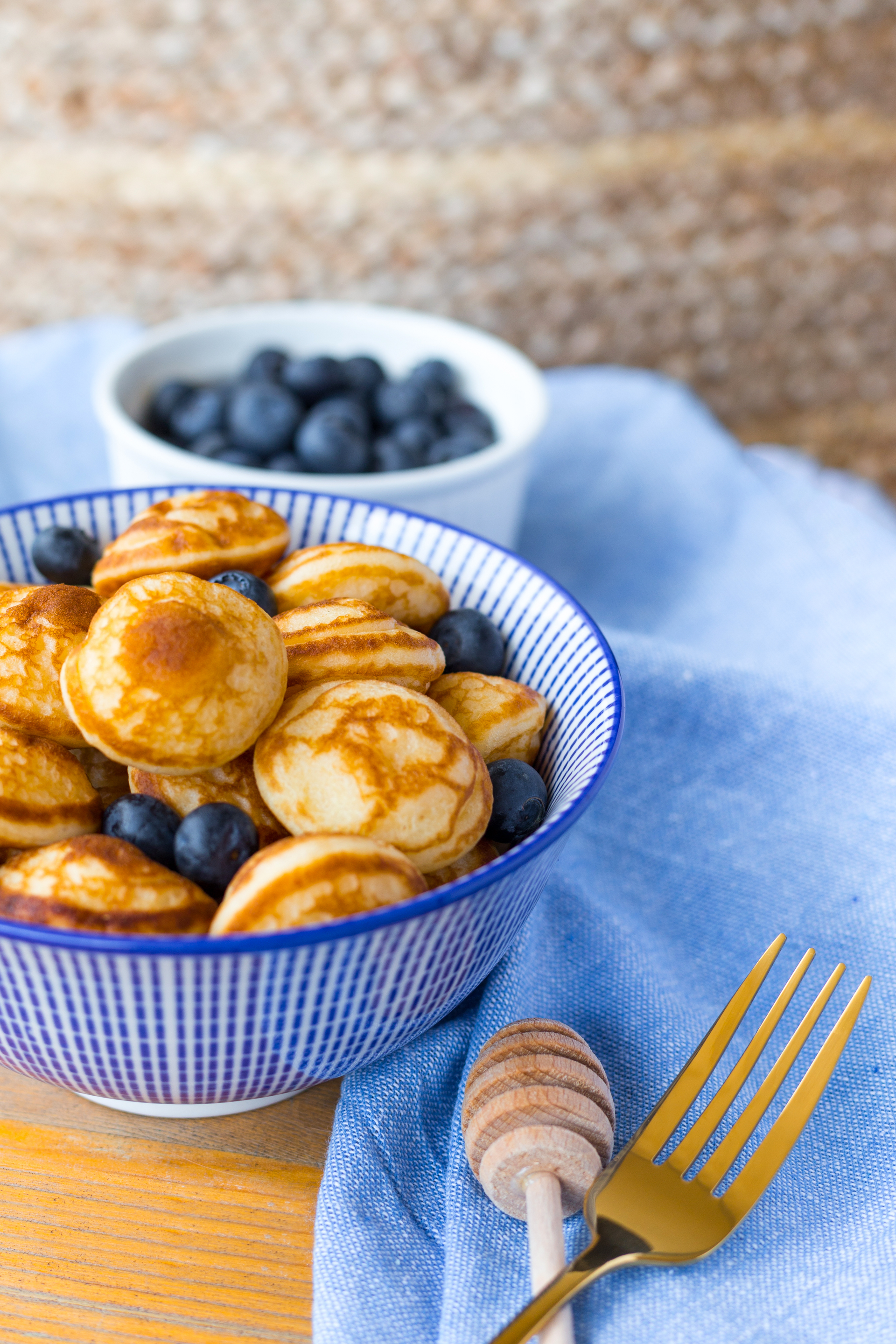 Overhead flat-lay of all ingredients for Dutch Poffertjes with Maple Butter laid out on a kitchen surface.