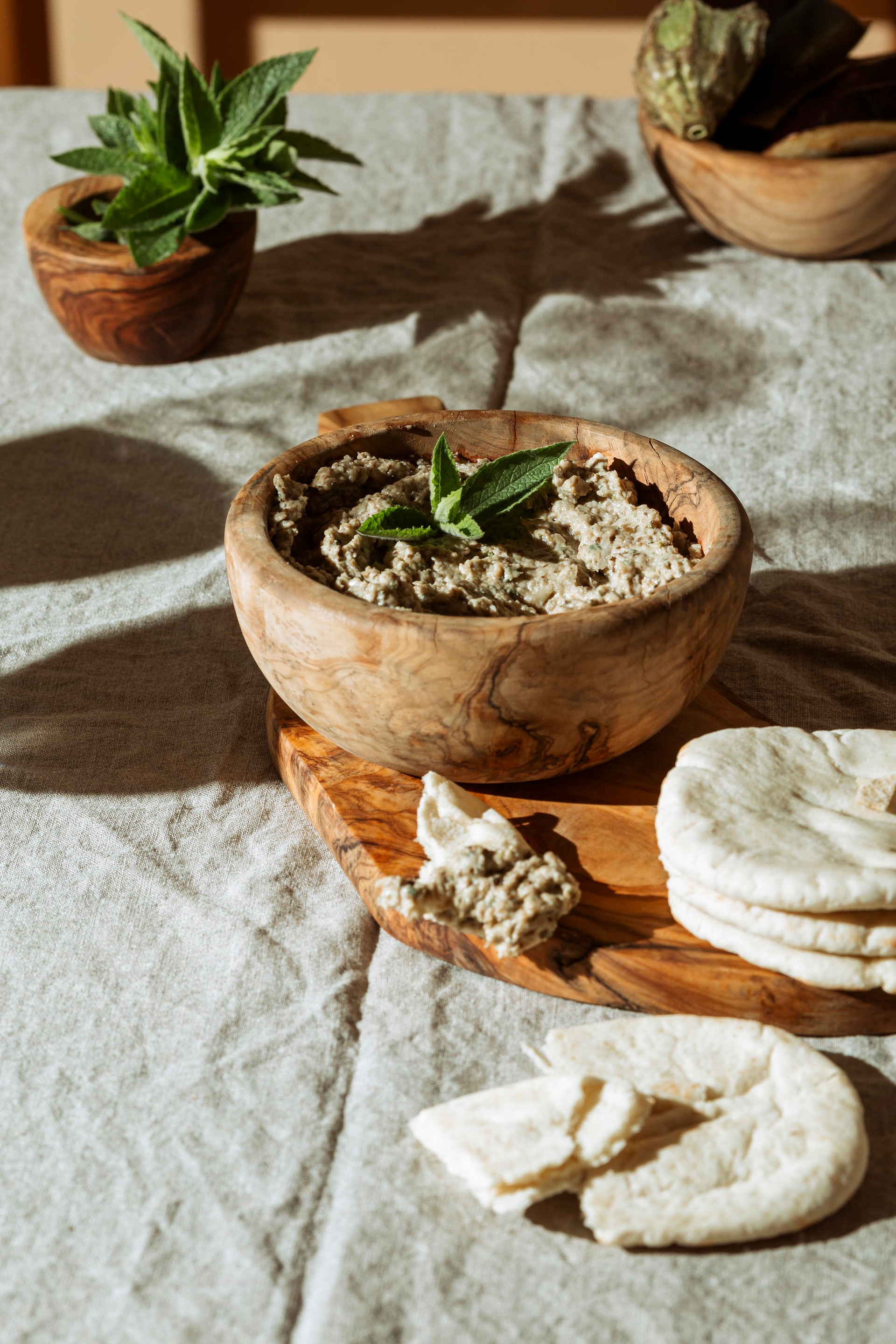 Overhead flat-lay of all ingredients for Earthy Armenian Spas with Yogurt and Barley laid out on a kitchen surface.