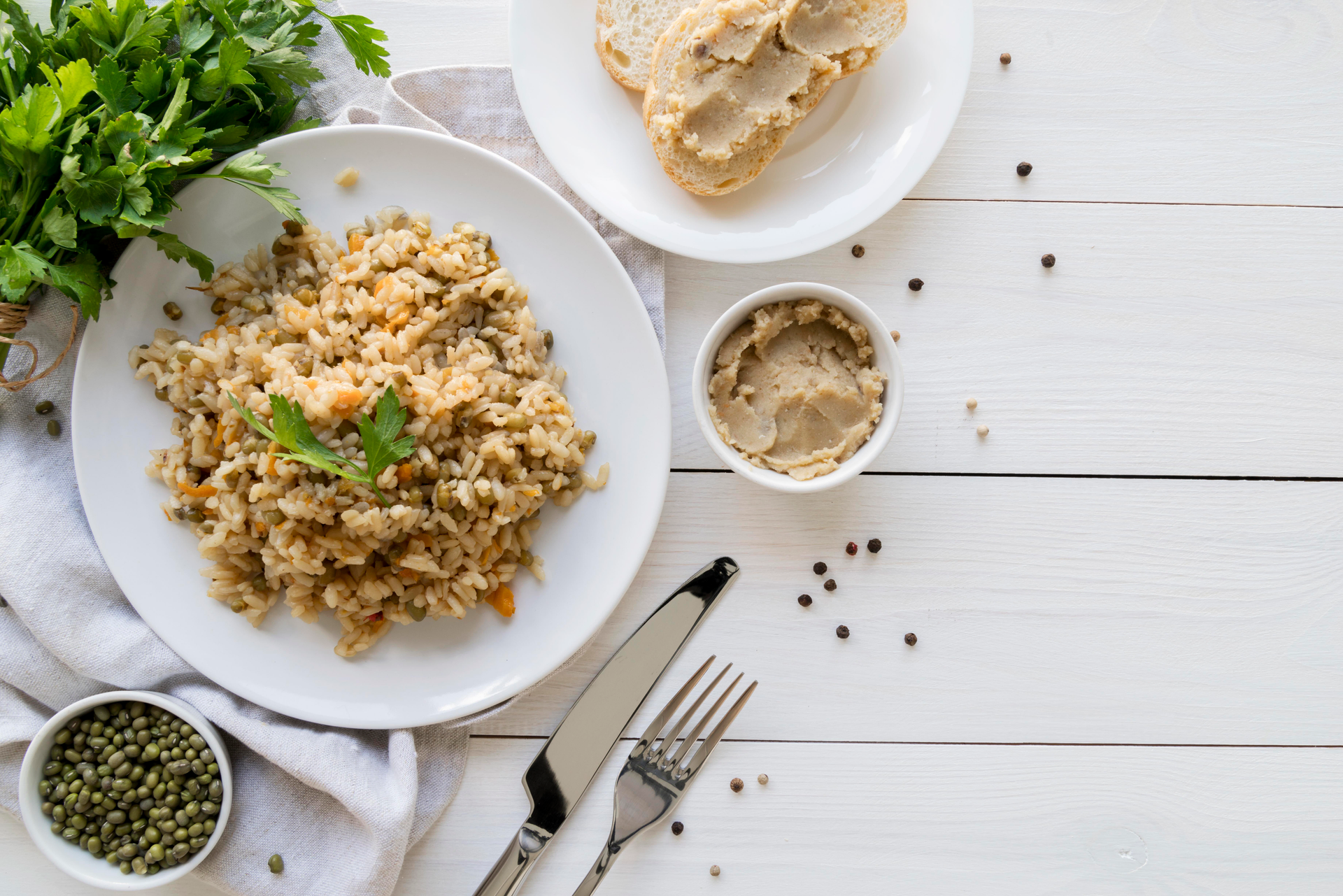 Overhead flat-lay of all ingredients for Earthy Italian Fennel and Sausage Risotto laid out on a kitchen surface.