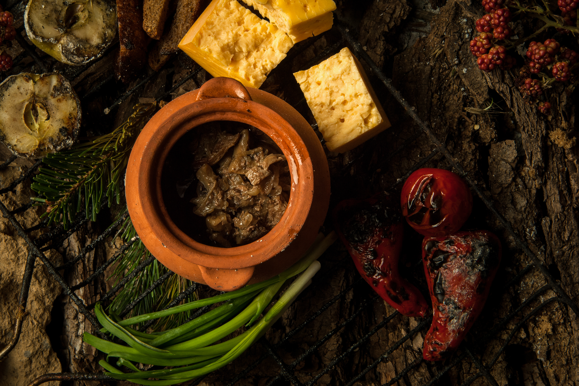 Overhead flat-lay of all ingredients for Earthy Peruvian Pachamanca with Herb-Marinated Meats laid out on a kitchen surface.