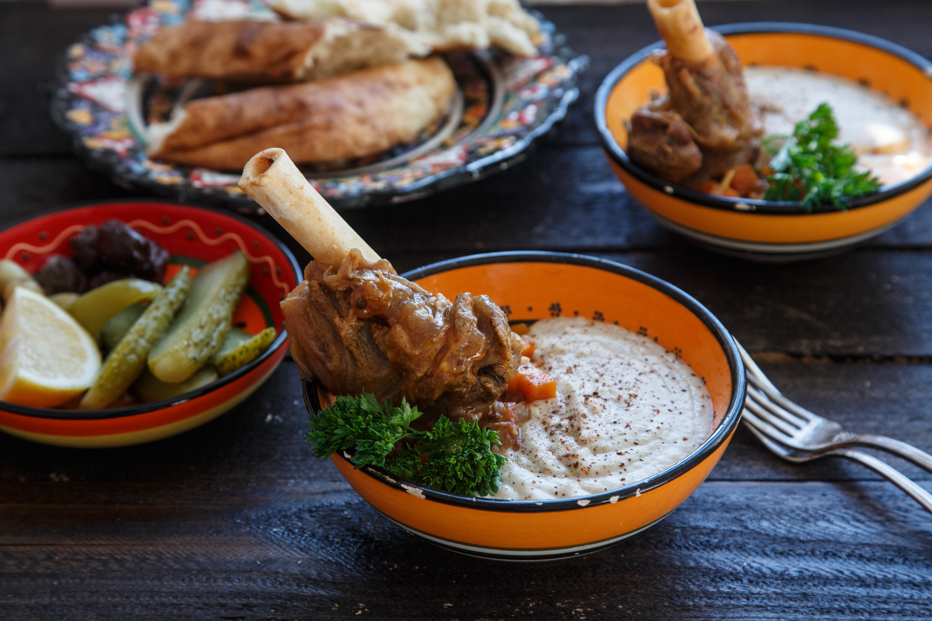 Overhead flat-lay of all ingredients for Egyptian Fatta with Lamb Shanks and Yogurt Sauce laid out on a kitchen surface.