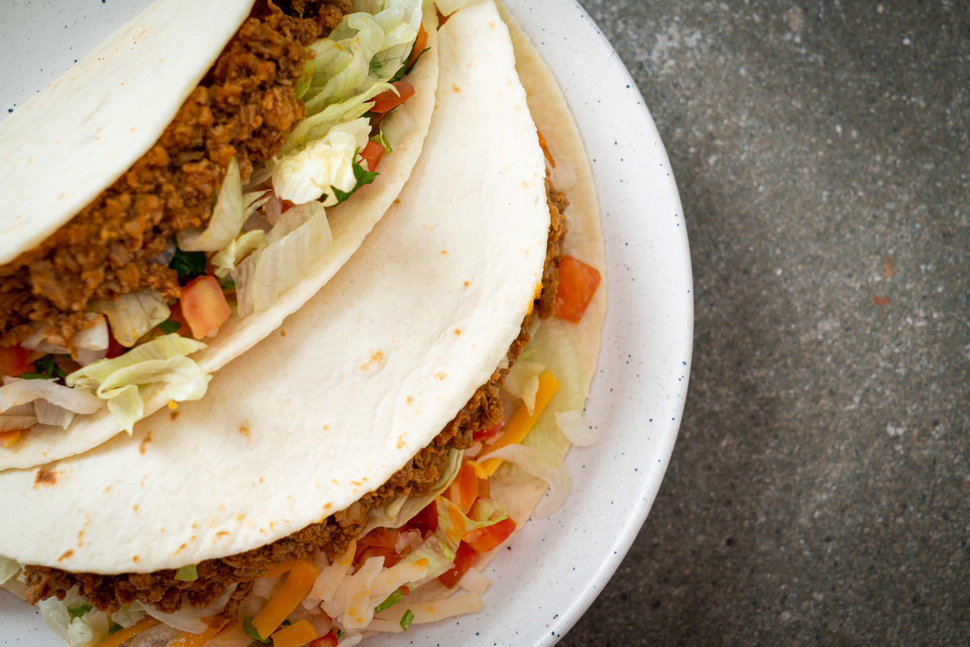 Overhead flat-lay of all ingredients for Ethiopian Berbere Lentil Tacos with Teff Tortillas laid out on a kitchen surface.