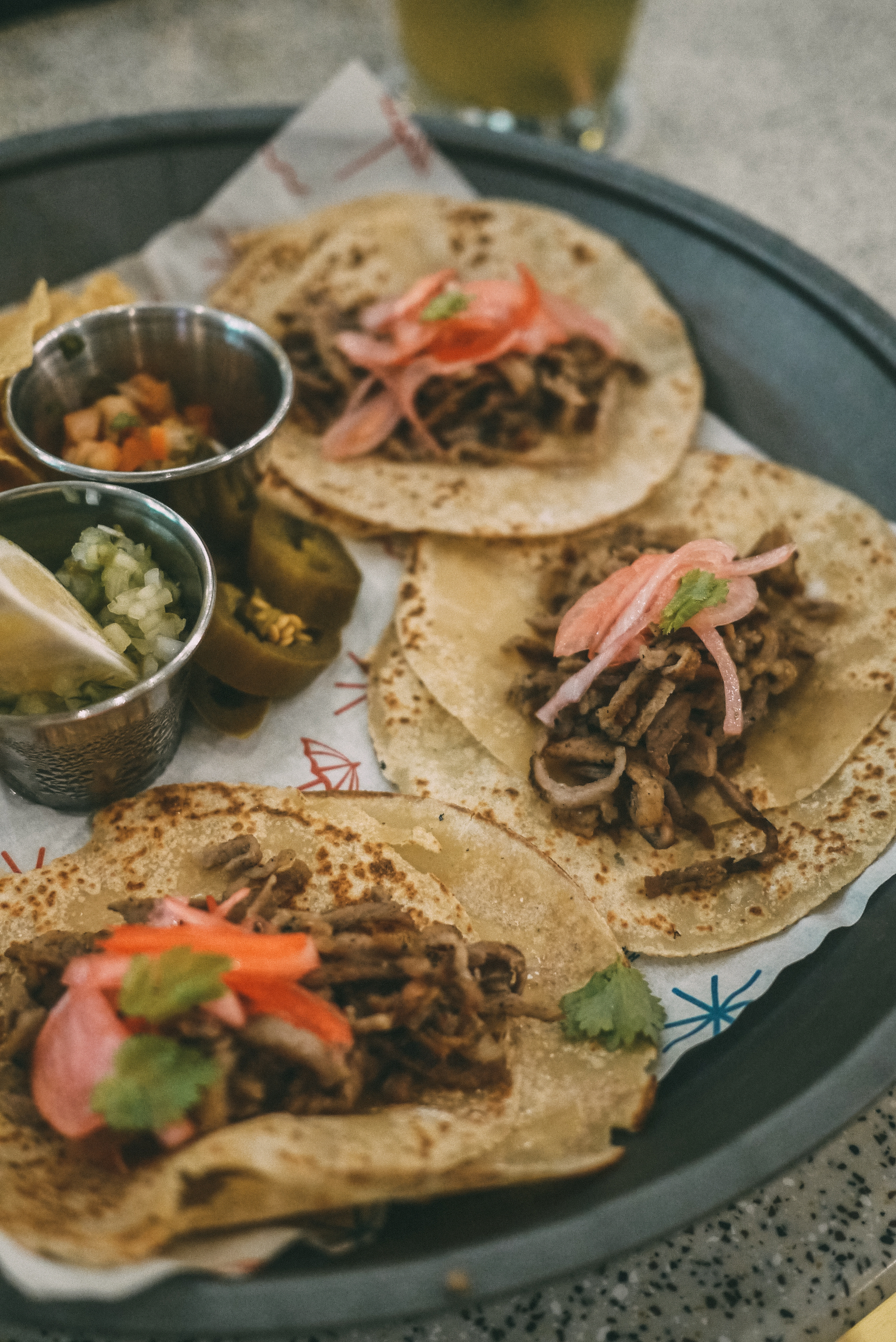 Overhead flat-lay of all ingredients for Ethiopian Injera Tacos with Spiced Lentil Fillings laid out on a kitchen surface.