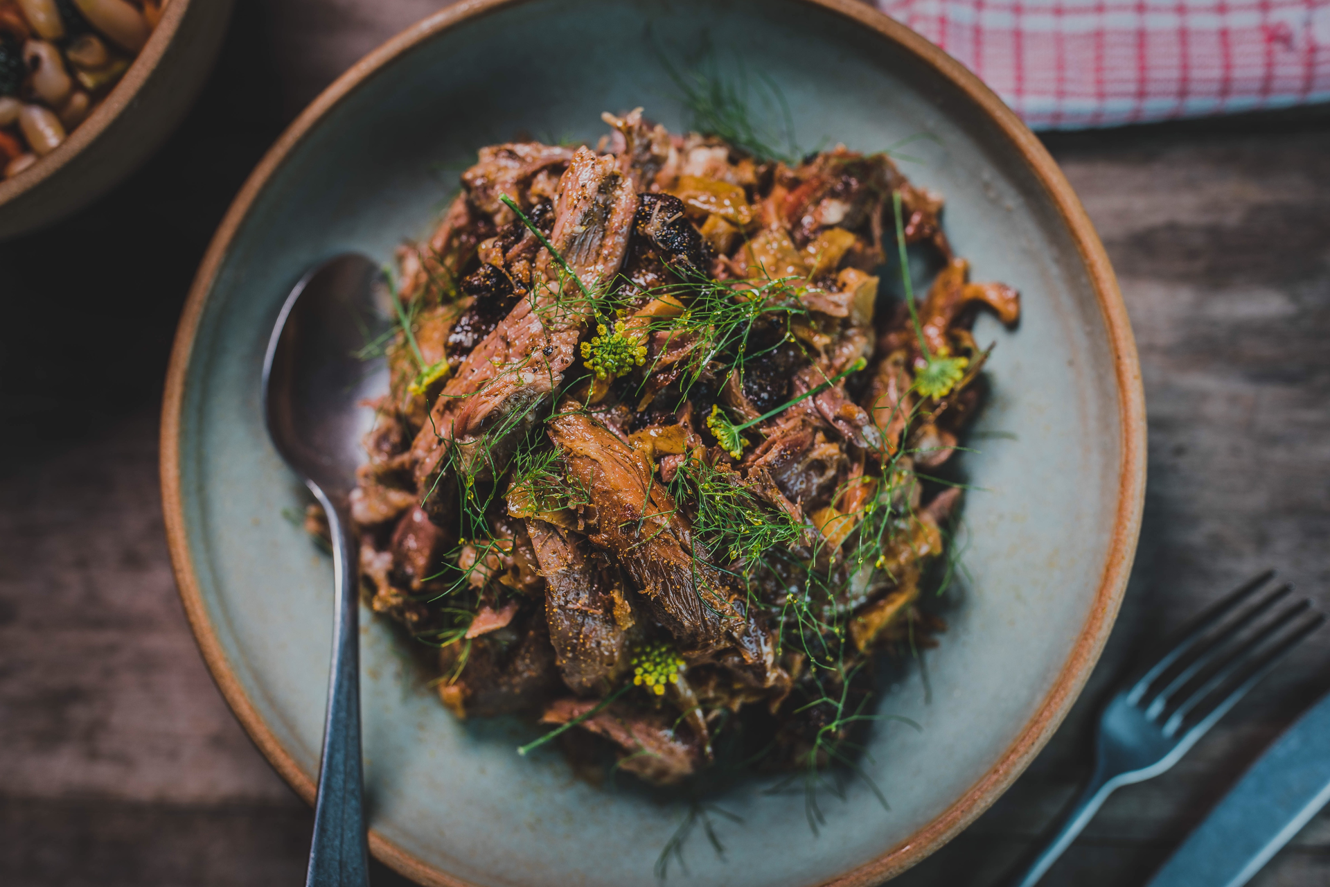 Overhead flat-lay of all ingredients for Ethiopian Lamb Tibs with Rosemary and Spiced Butter laid out on a kitchen surface.