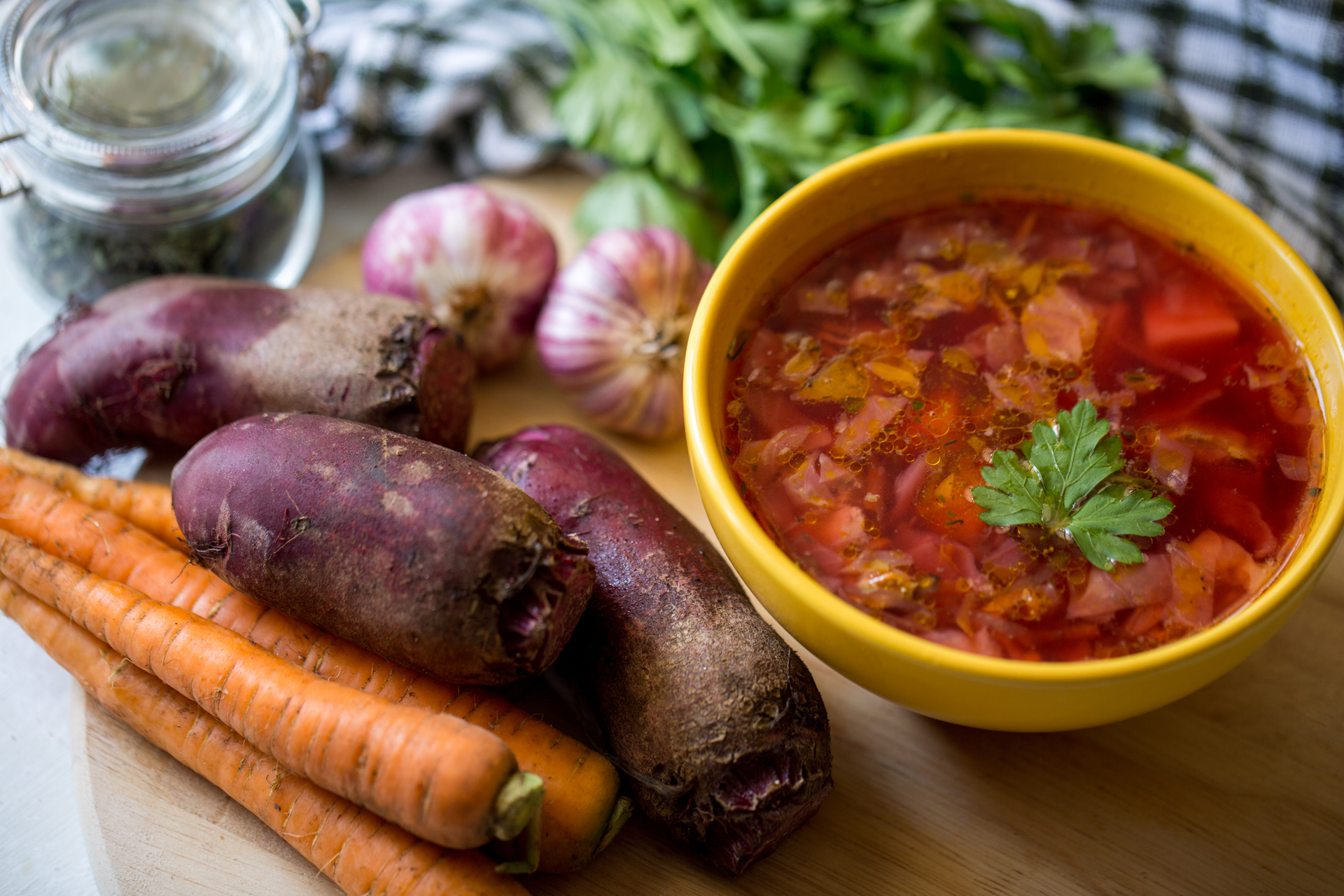 Overhead flat-lay of all ingredients for Ethiopian Spiced Beet Stew with Ginger and Coriander laid out on a kitchen surface.