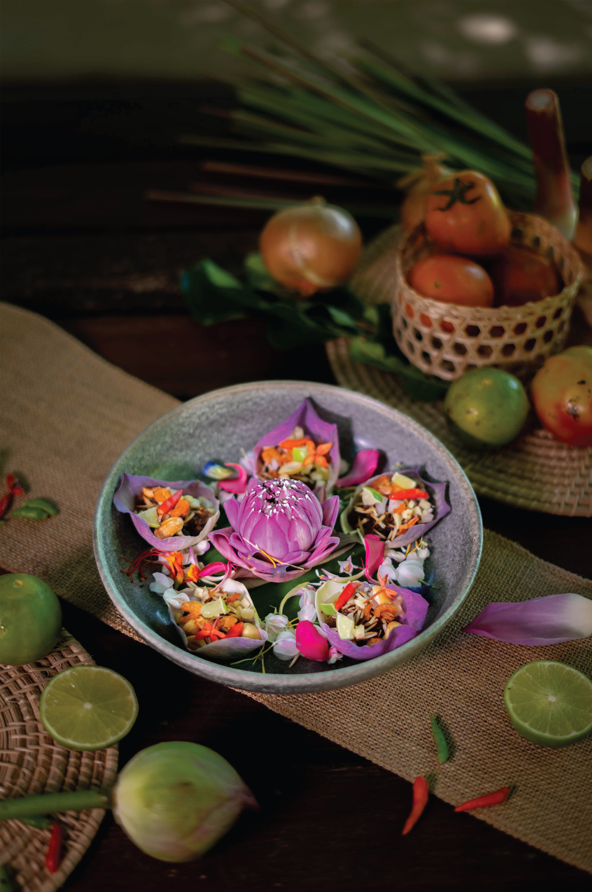 Overhead flat-lay of all ingredients for Exotic Burmese Ngapi Salad laid out on a kitchen surface.