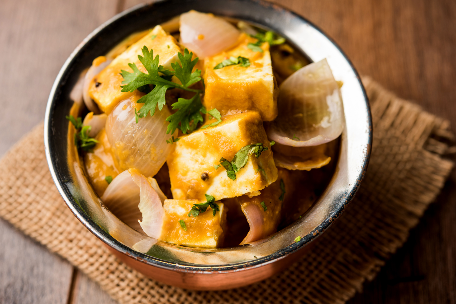 Overhead flat-lay of all ingredients for Exotic Caribbean Coconut Curry Tofu with Mango Ginger Sauce laid out on a kitchen surface.
