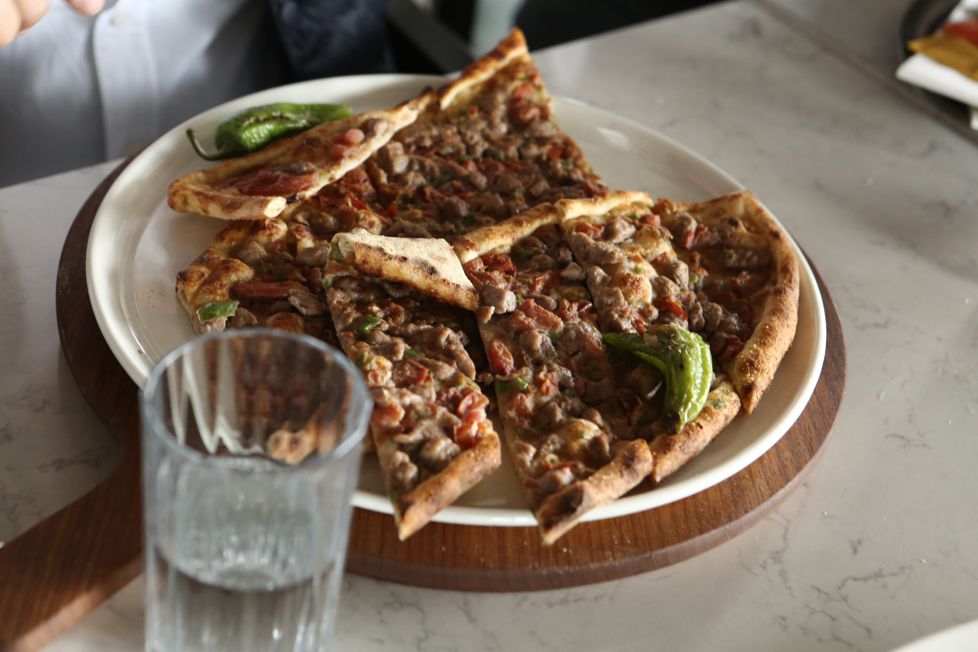 Overhead flat-lay of all ingredients for Exotic Egyptian Hawawshi with Spiced Minced Meat laid out on a kitchen surface.