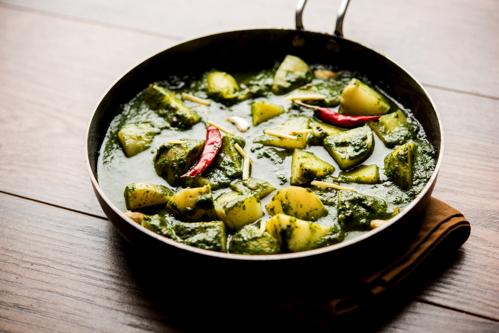 Overhead flat-lay of all ingredients for Exotic Indian Kadai Paneer with Green Bell Peppers laid out on a kitchen surface.