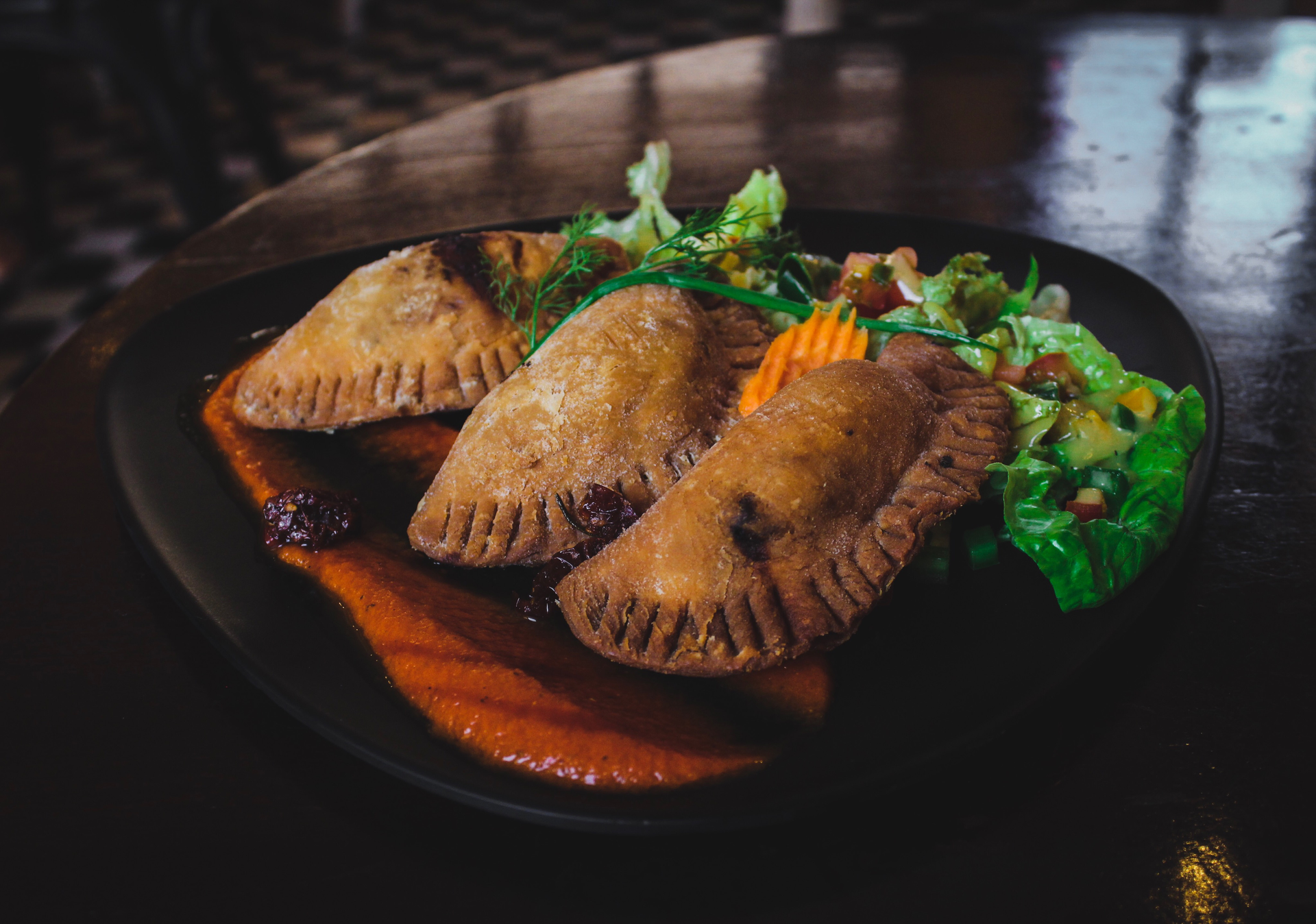 Overhead flat-lay of all ingredients for Exotic Jamaican Patties with Spicy Beef Filling laid out on a kitchen surface.