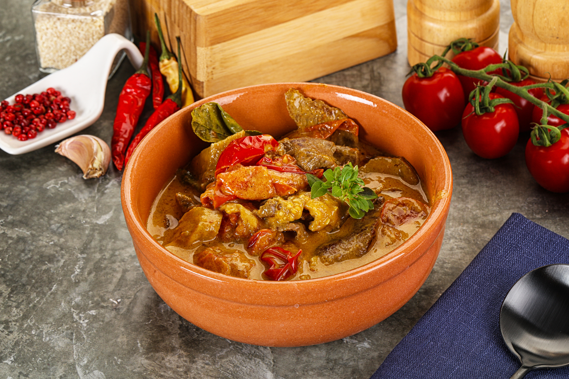 Overhead flat-lay of all ingredients for Exotic Tunisian Mloukhia Stew laid out on a kitchen surface.