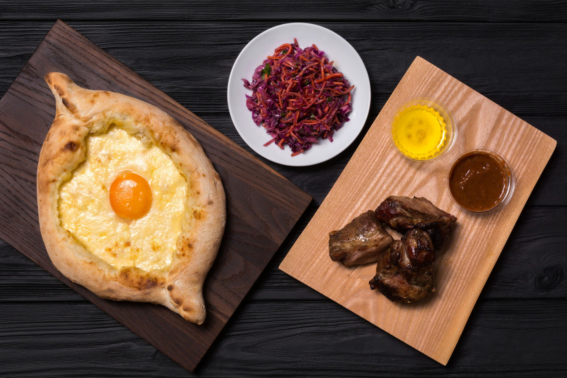 Overhead flat-lay of all ingredients for Exotic Turkish Pide with Spiced Beef and Eggs laid out on a kitchen surface.