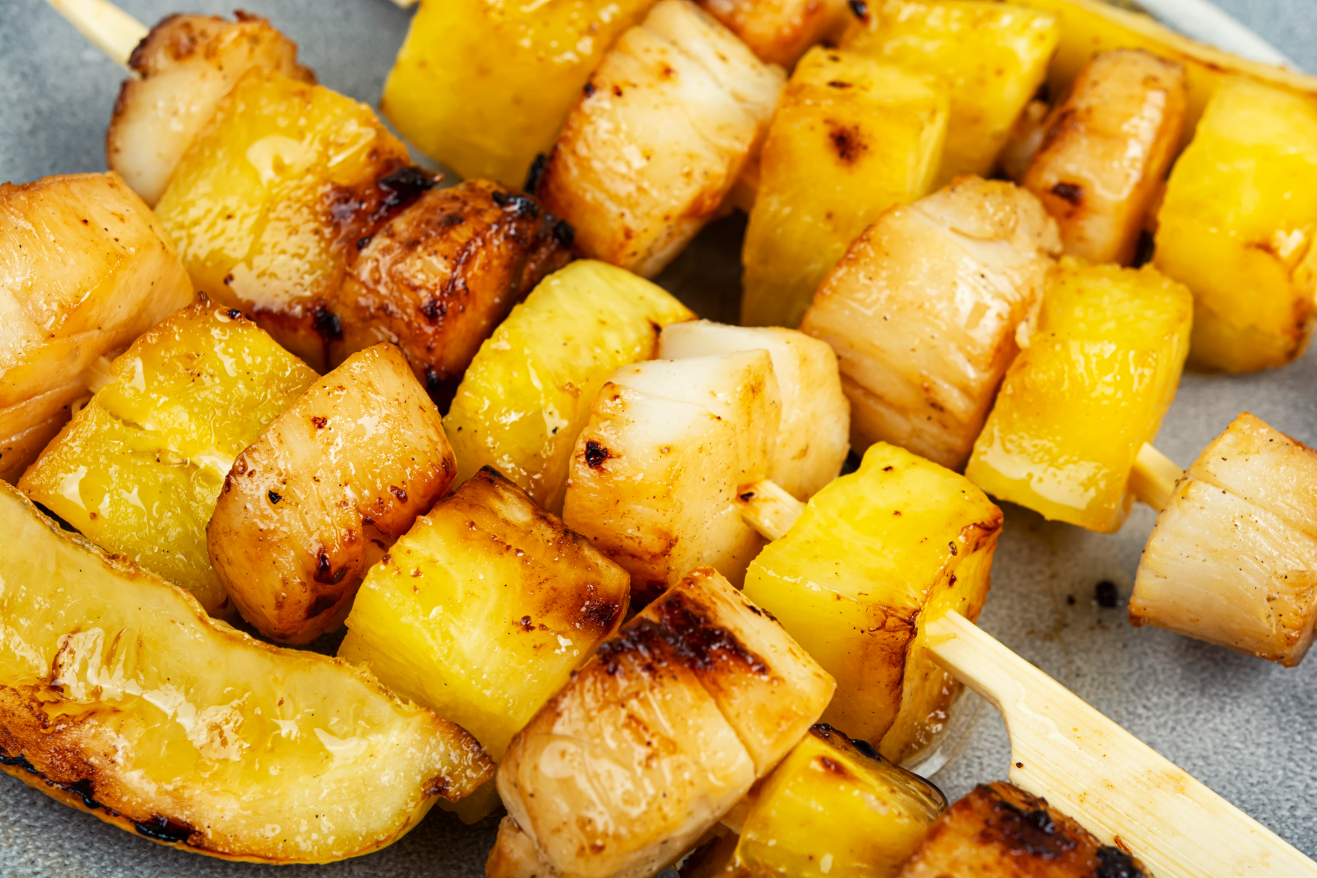 Overhead flat-lay of all ingredients for Fiery Caribbean Jerk Tofu Skewers with Pineapple Salsa laid out on a kitchen surface.
