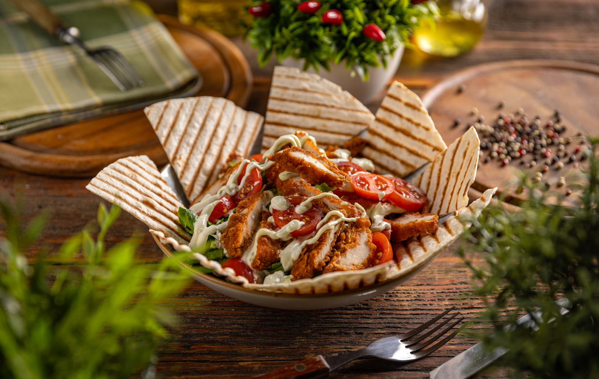Overhead flat-lay of all ingredients for Fiery Greek Chicken Gyros with Feta and Hot Pepper Spread laid out on a kitchen surface.