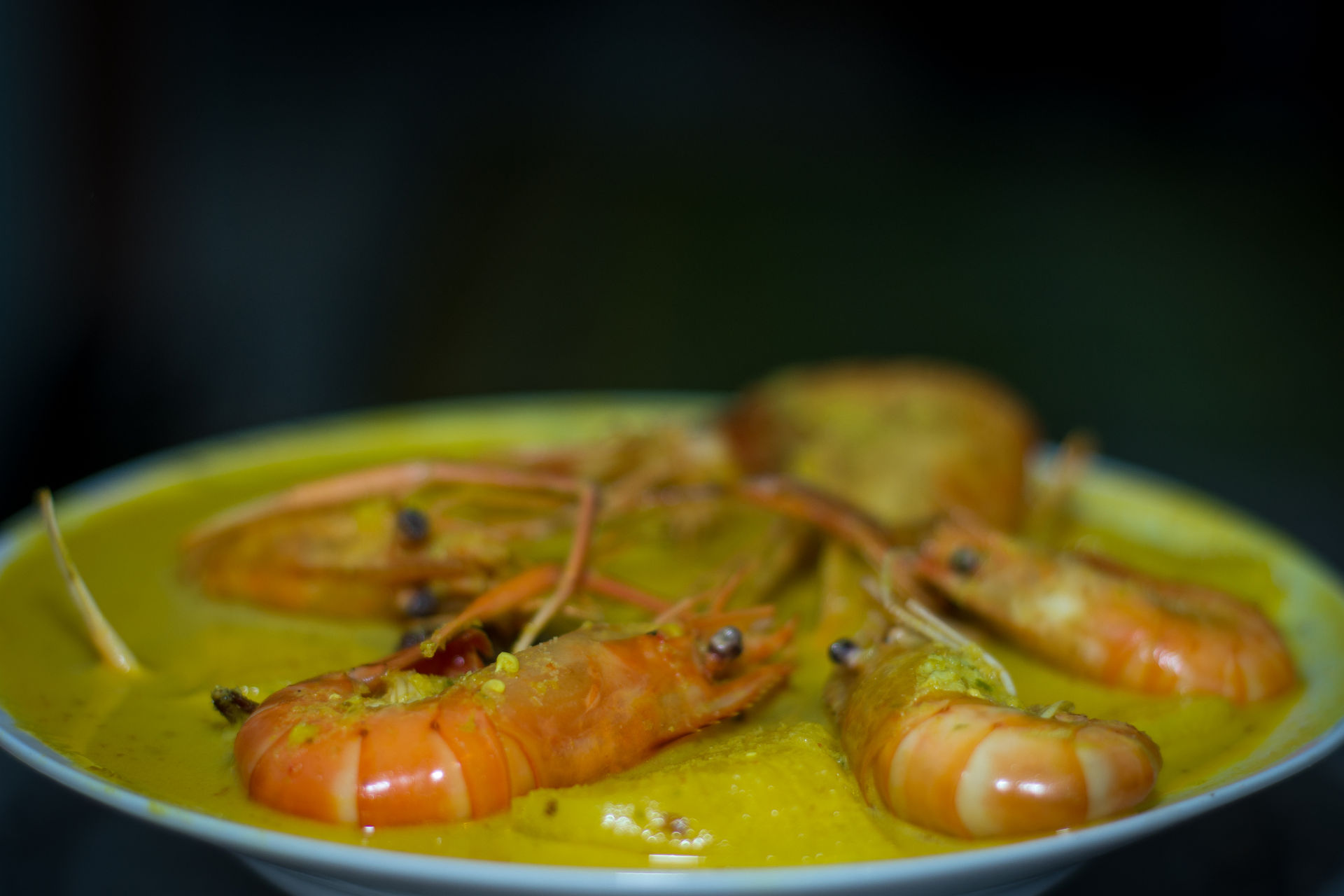 Overhead flat-lay of all ingredients for Fiery Jamaican Coconut Curry Shrimp with Mango and Lime laid out on a kitchen surface.