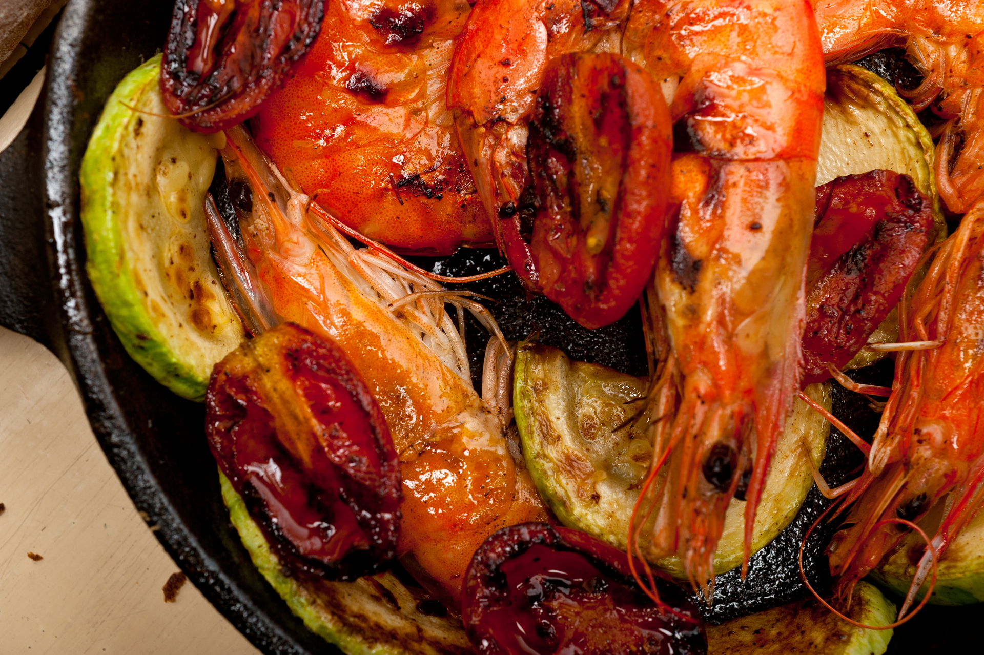 Overhead flat-lay of all ingredients for Fiery Jamaican Hot Pepper Shrimp laid out on a kitchen surface.