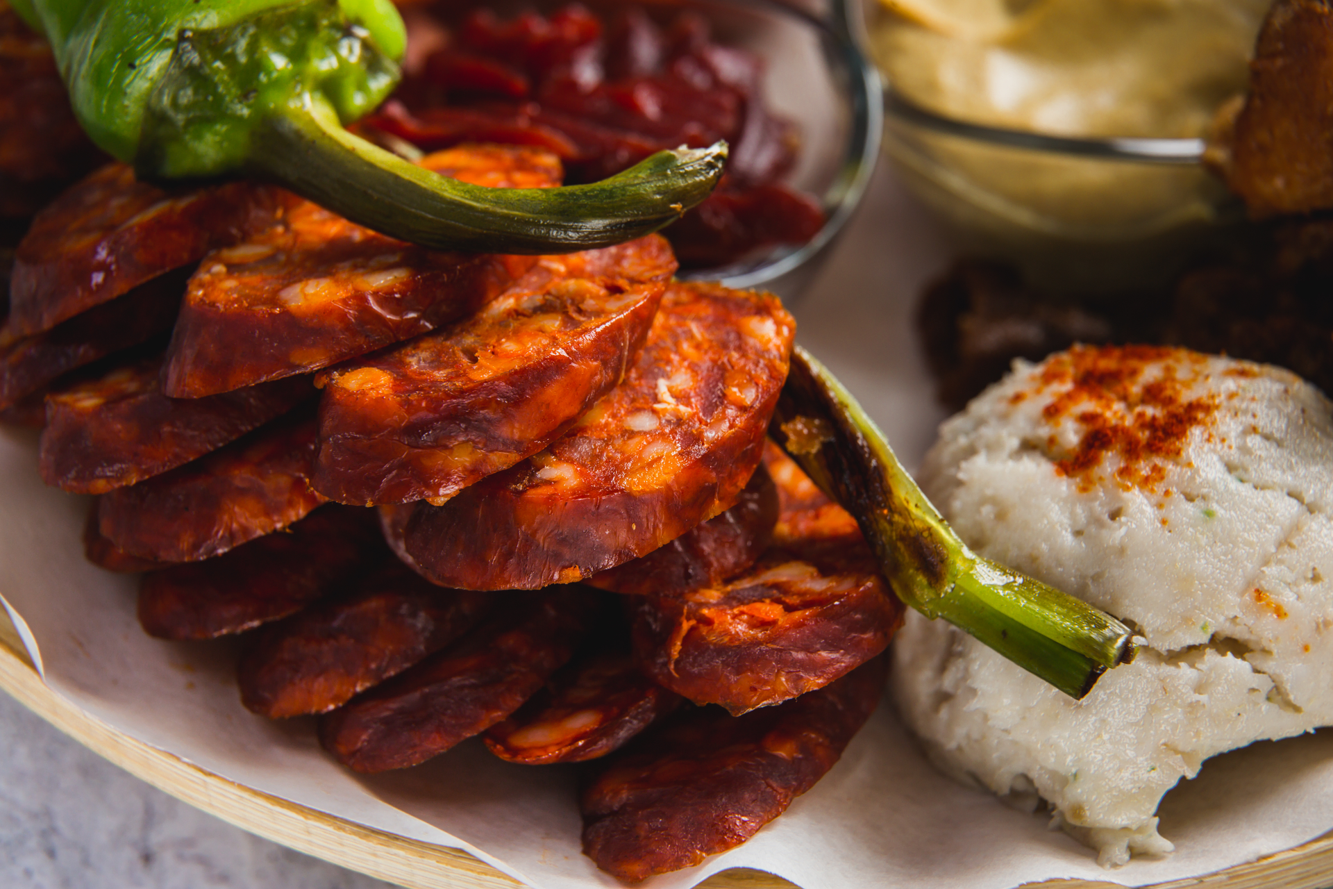 Overhead flat-lay of all ingredients for Fiery Jamaican Scotch Bonnet Chicken Curry with Grilled Plantains laid out on a kitchen surface.