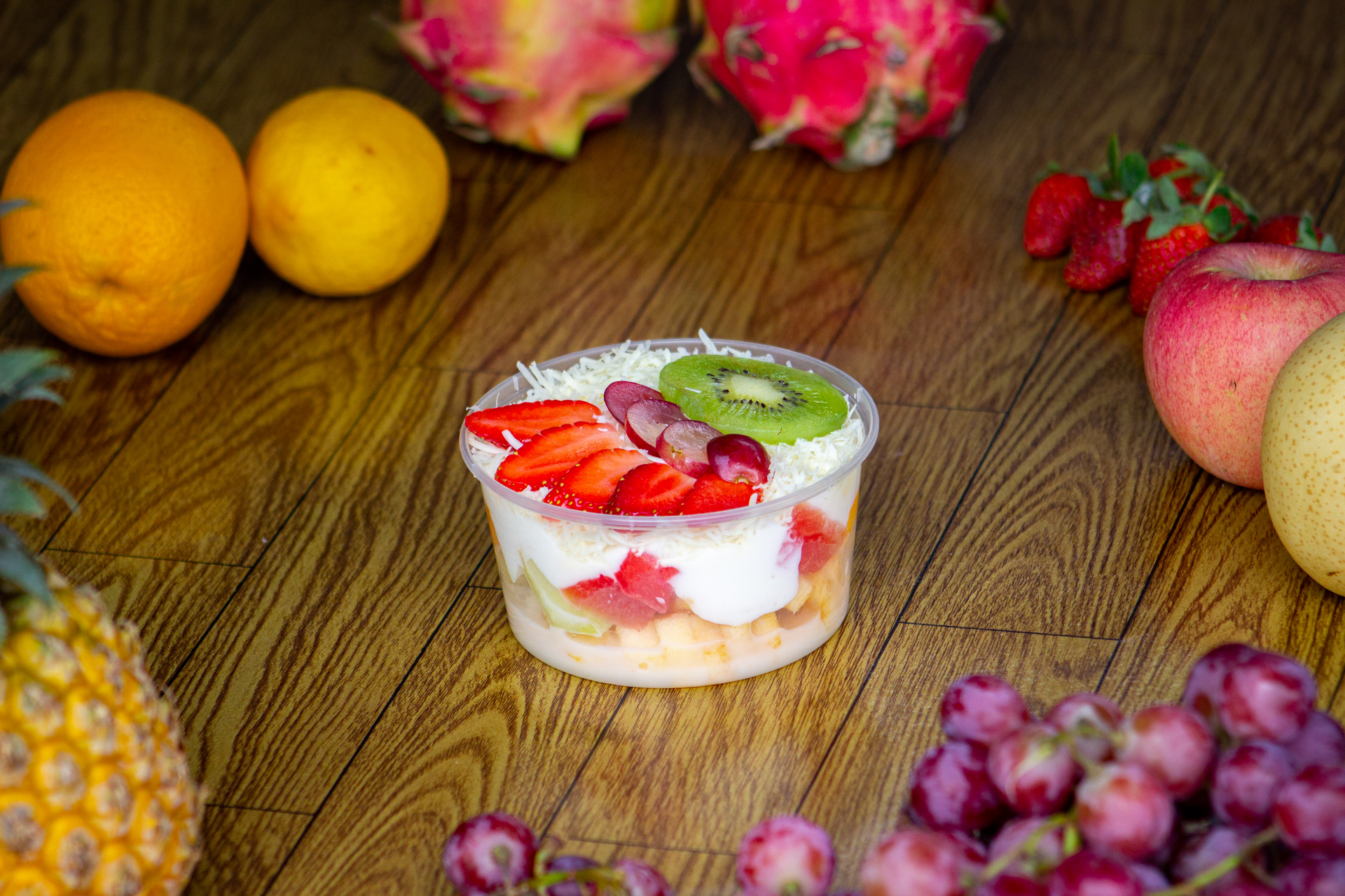 Overhead flat-lay of all ingredients for Filipino Halo-Halo Parfait with Tropical Fruits and Leche Flan laid out on a kitchen surface.