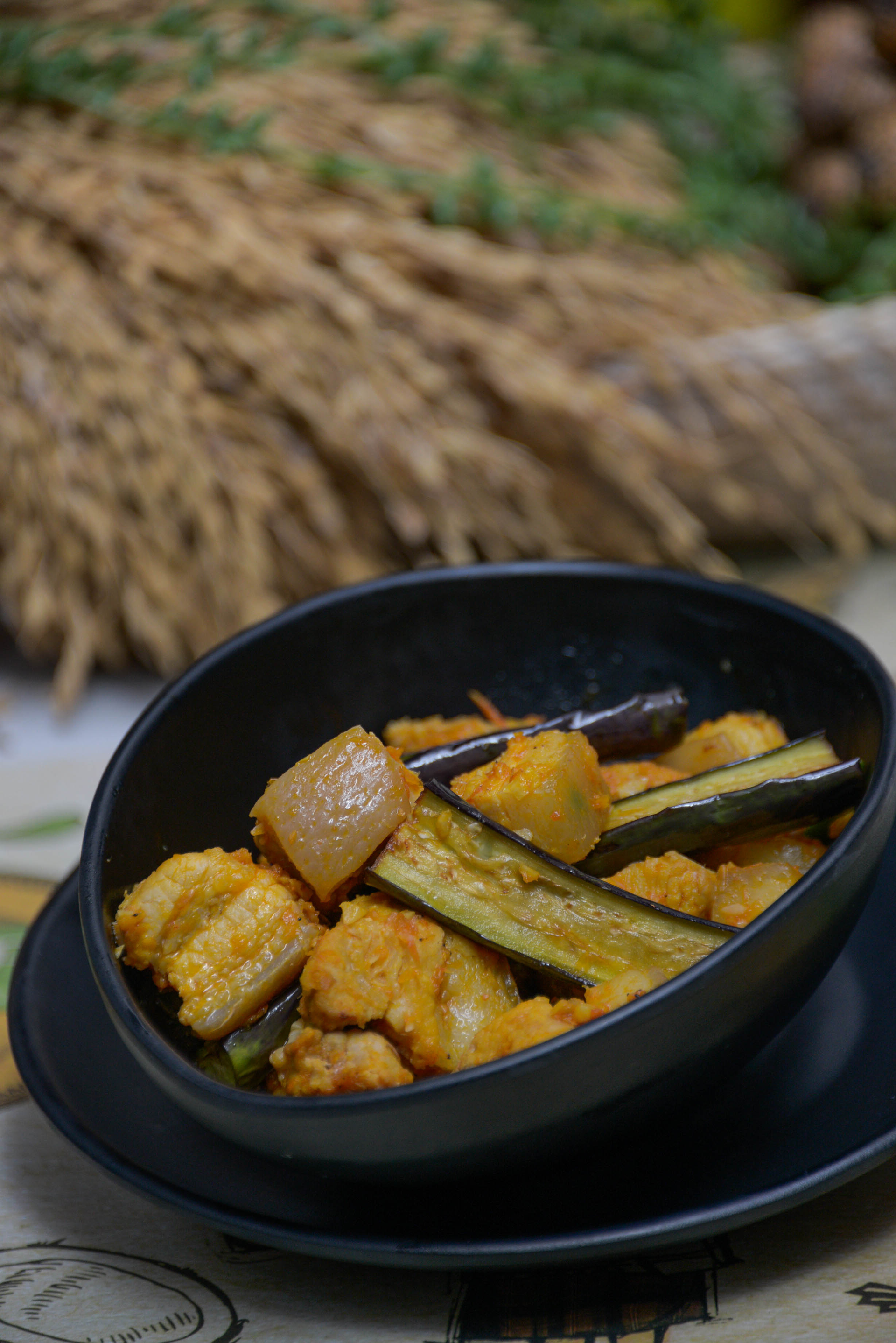 Overhead flat-lay of all ingredients for Filipino Pinakbet with Bitter Melon and Eggplant laid out on a kitchen surface.