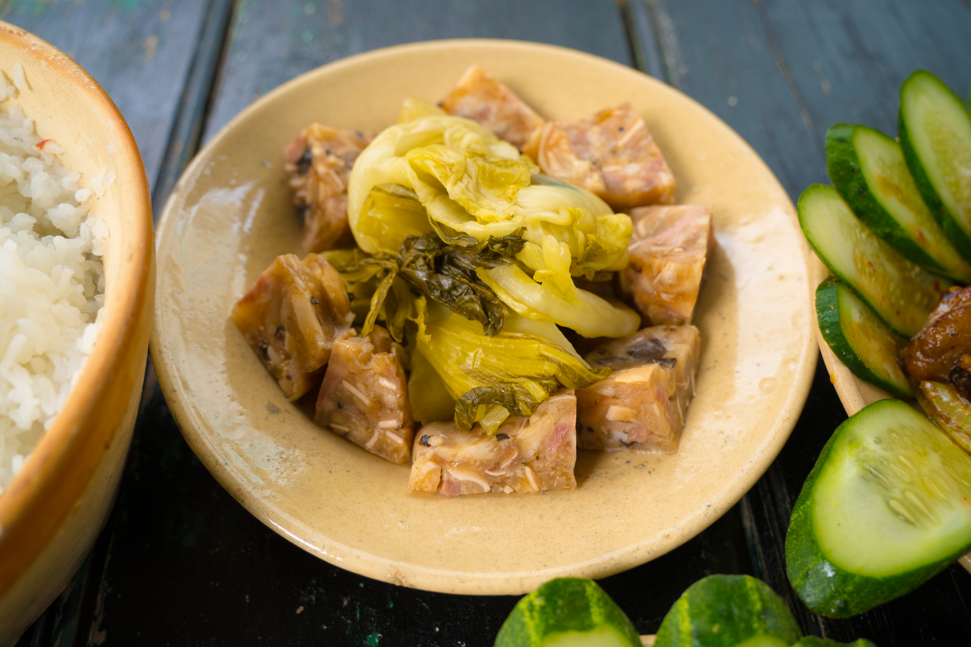 Overhead flat-lay of all ingredients for Filipino Sinigang with Tamarind and Pork laid out on a kitchen surface.