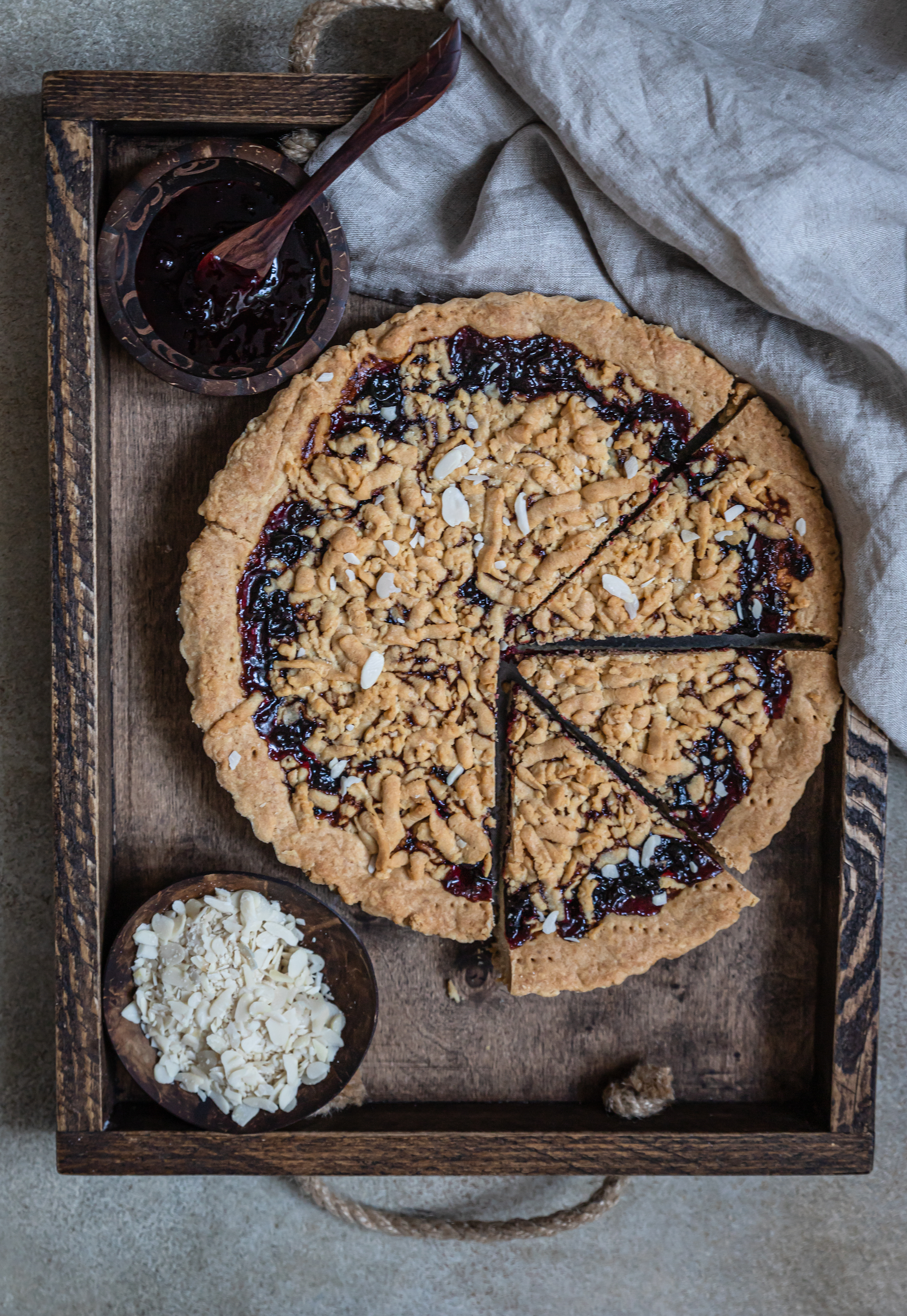 Overhead flat-lay of all ingredients for Finnish Bilberry Pie with Spiced Rye Crust laid out on a kitchen surface.