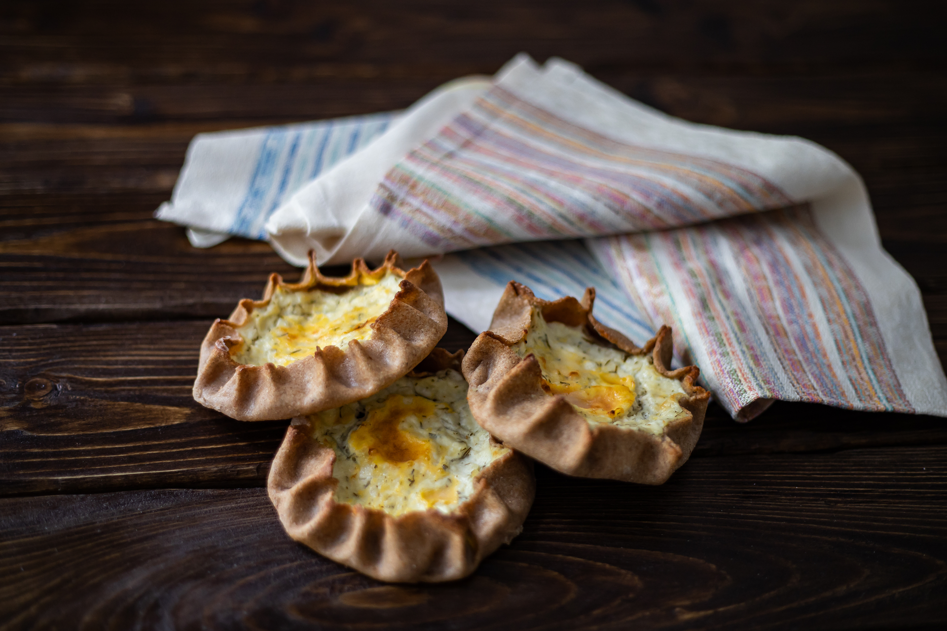 Overhead flat-lay of all ingredients for Flaky Finnish Karjalanpiirakka with Egg Butter laid out on a kitchen surface.
