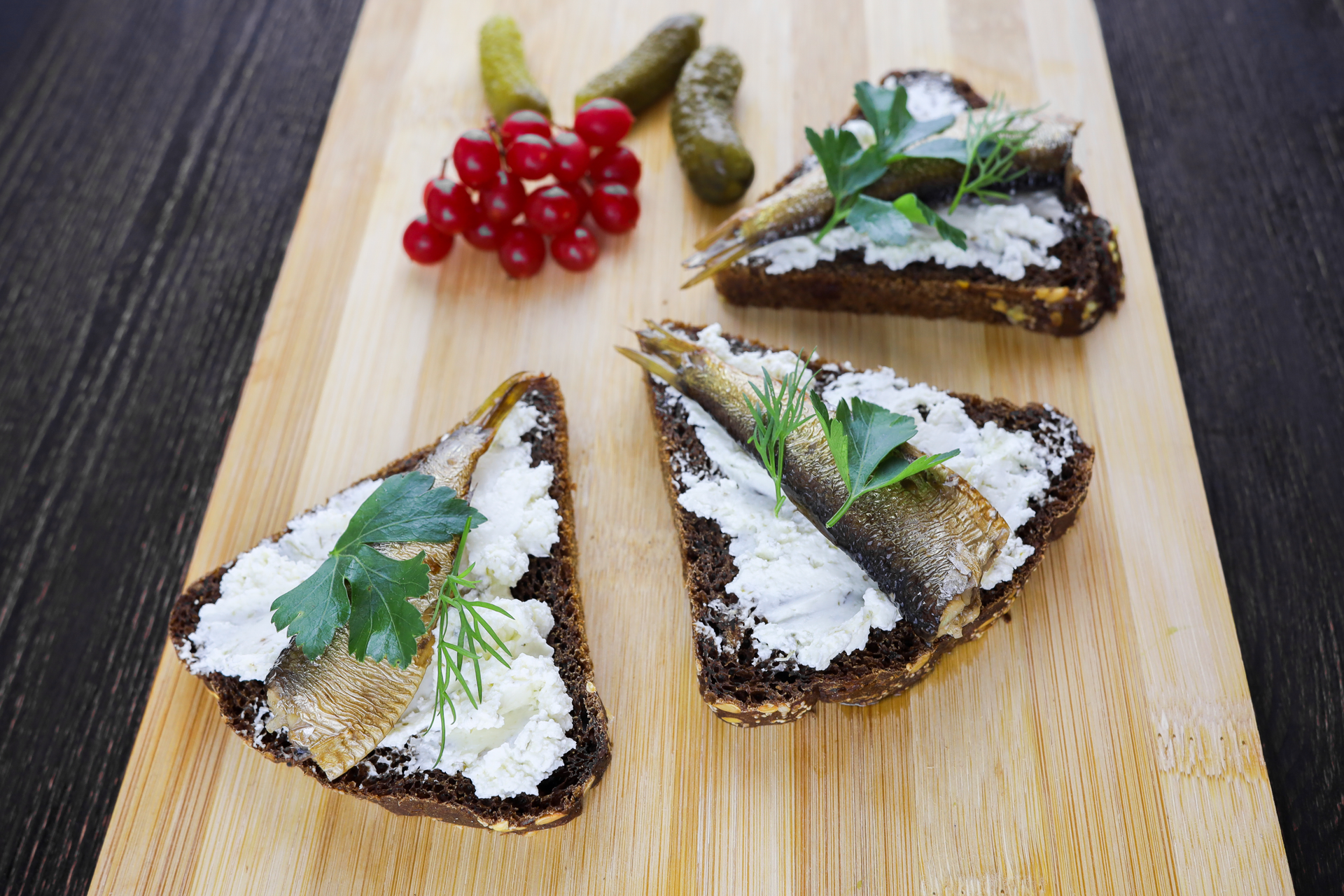 Overhead flat-lay of all ingredients for Flavorful Finnish Kalakukko with Herring and Rye Crust laid out on a kitchen surface.