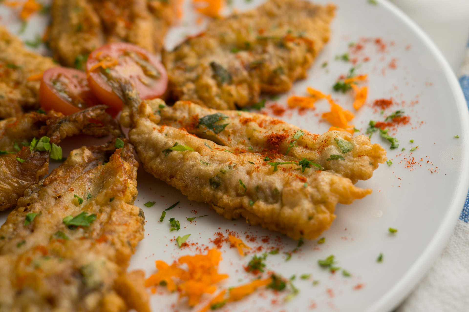 Overhead flat-lay of all ingredients for Flavorful Jamaican Callaloo and Saltfish Fritters with Scotch Bonnet Mayo laid out on a kitchen surface.