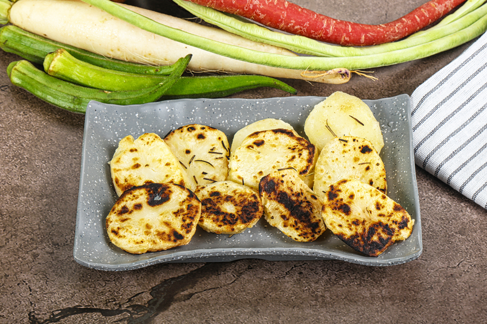Overhead flat-lay of all ingredients for Flavorful Venezuelan Tostones with Queso Fresco and Avocado Salsa laid out on a kitchen surface.