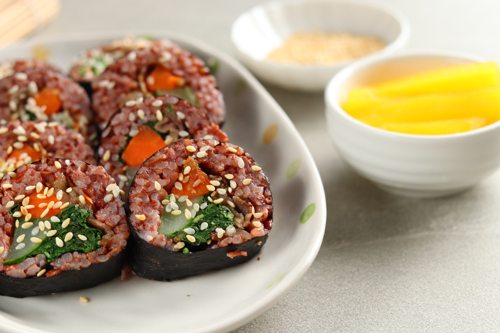 Overhead flat-lay of all ingredients for Flavorsome Korean Kimbap with Pickled Radish and Beef laid out on a kitchen surface.
