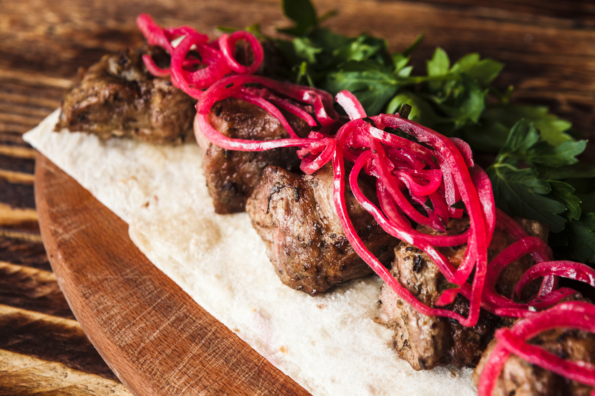 Overhead flat-lay of all ingredients for Flavorsome Kurdish Kebab with Sumac and Flatbread laid out on a kitchen surface.
