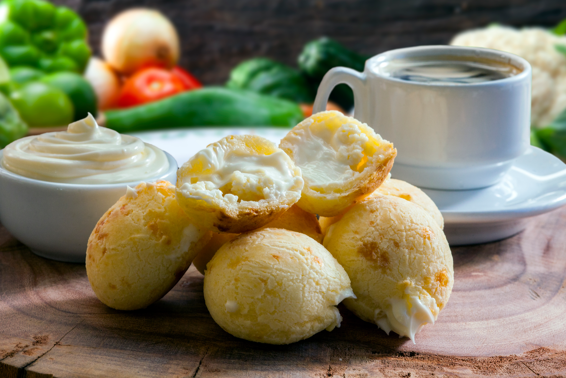 Overhead flat-lay of all ingredients for Fluffy Brazilian Cheese Rolls with Garlic Herb Butter laid out on a kitchen surface.
