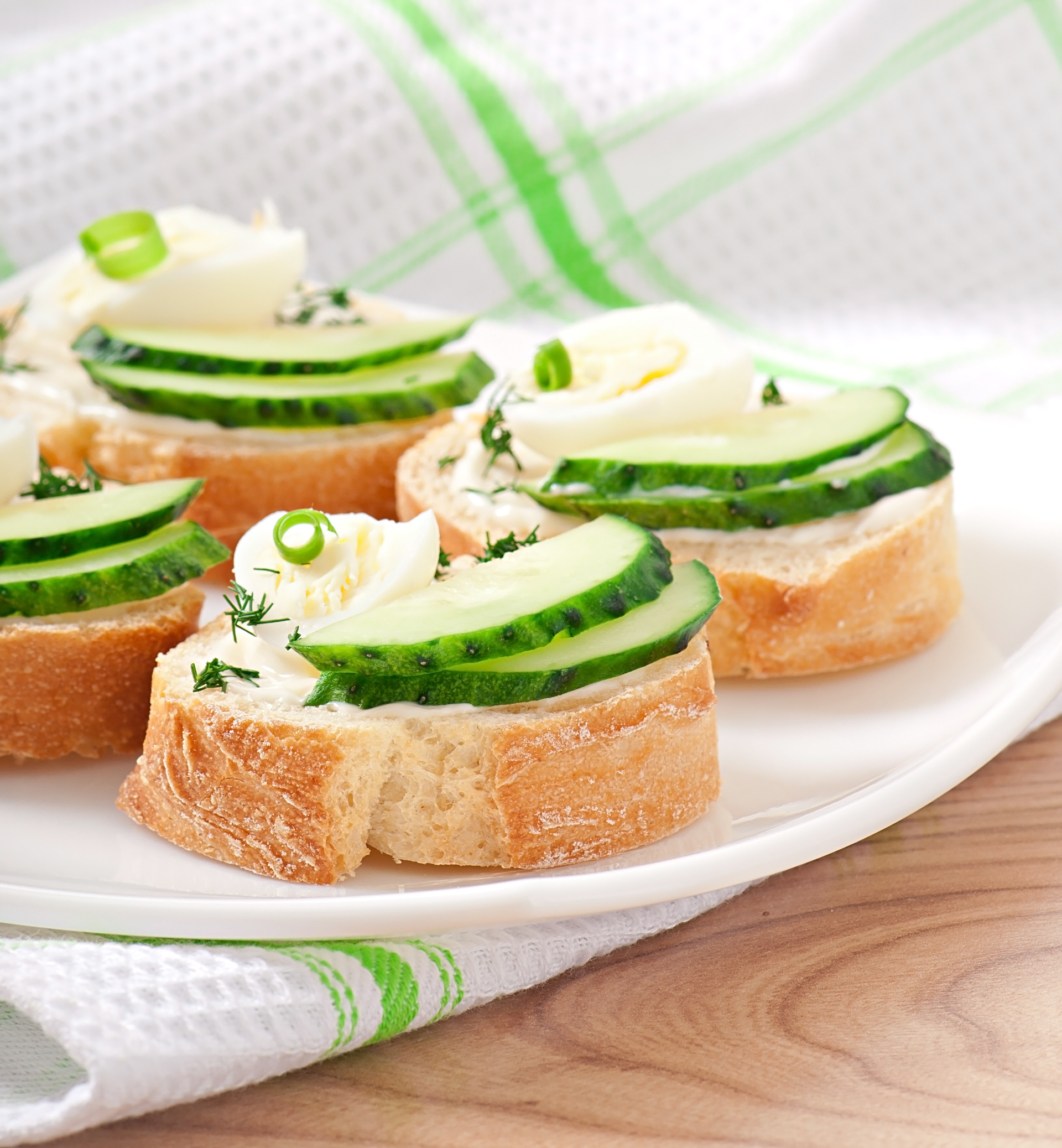 Overhead flat-lay of all ingredients for Fluffy British Cucumber Sandwiches with Herbed Cream Cheese laid out on a kitchen surface.