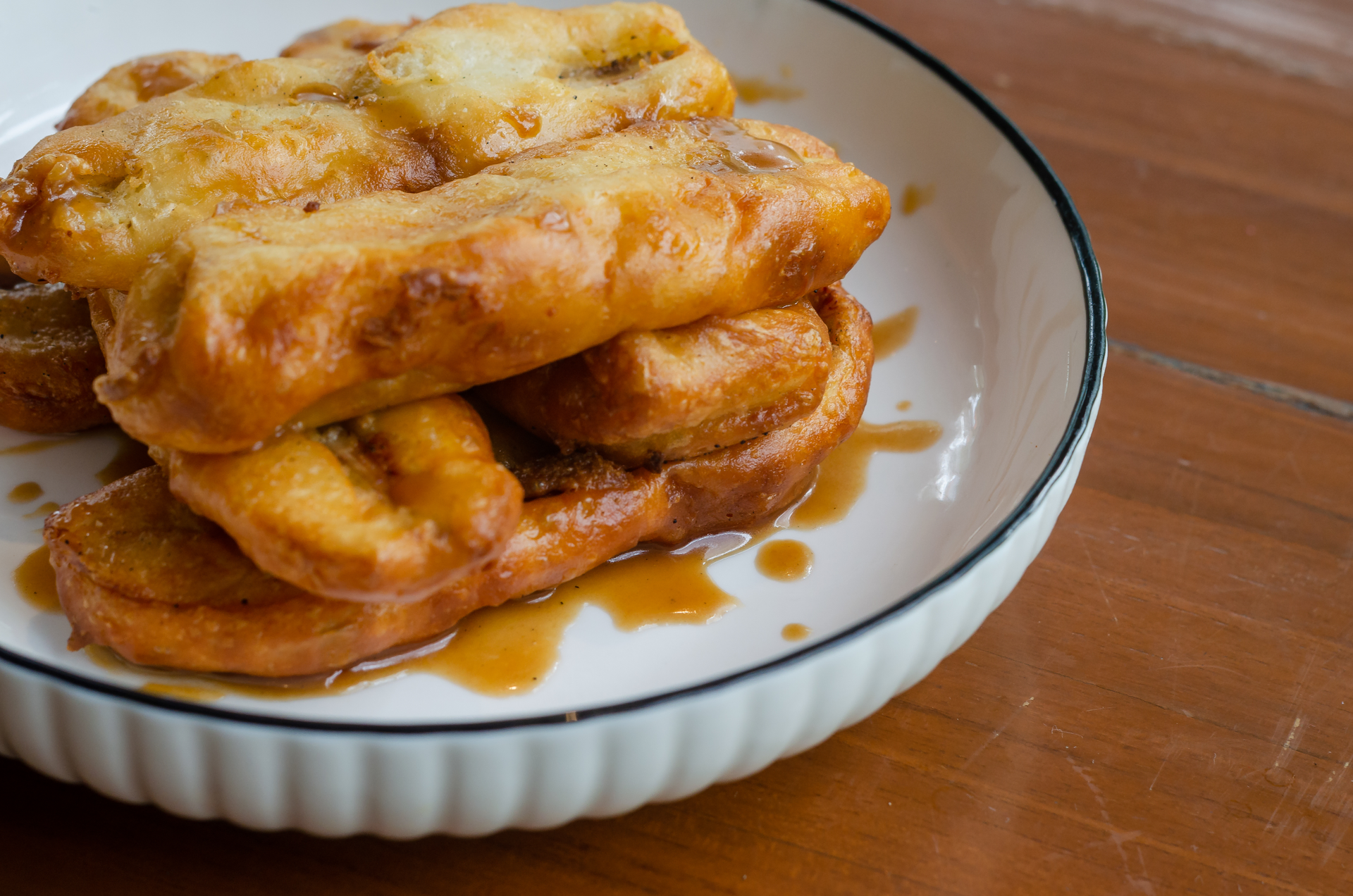 Overhead flat-lay of all ingredients for Fluffy Uruguayan Tortas Fritas with Cane Syrup Drizzle laid out on a kitchen surface.