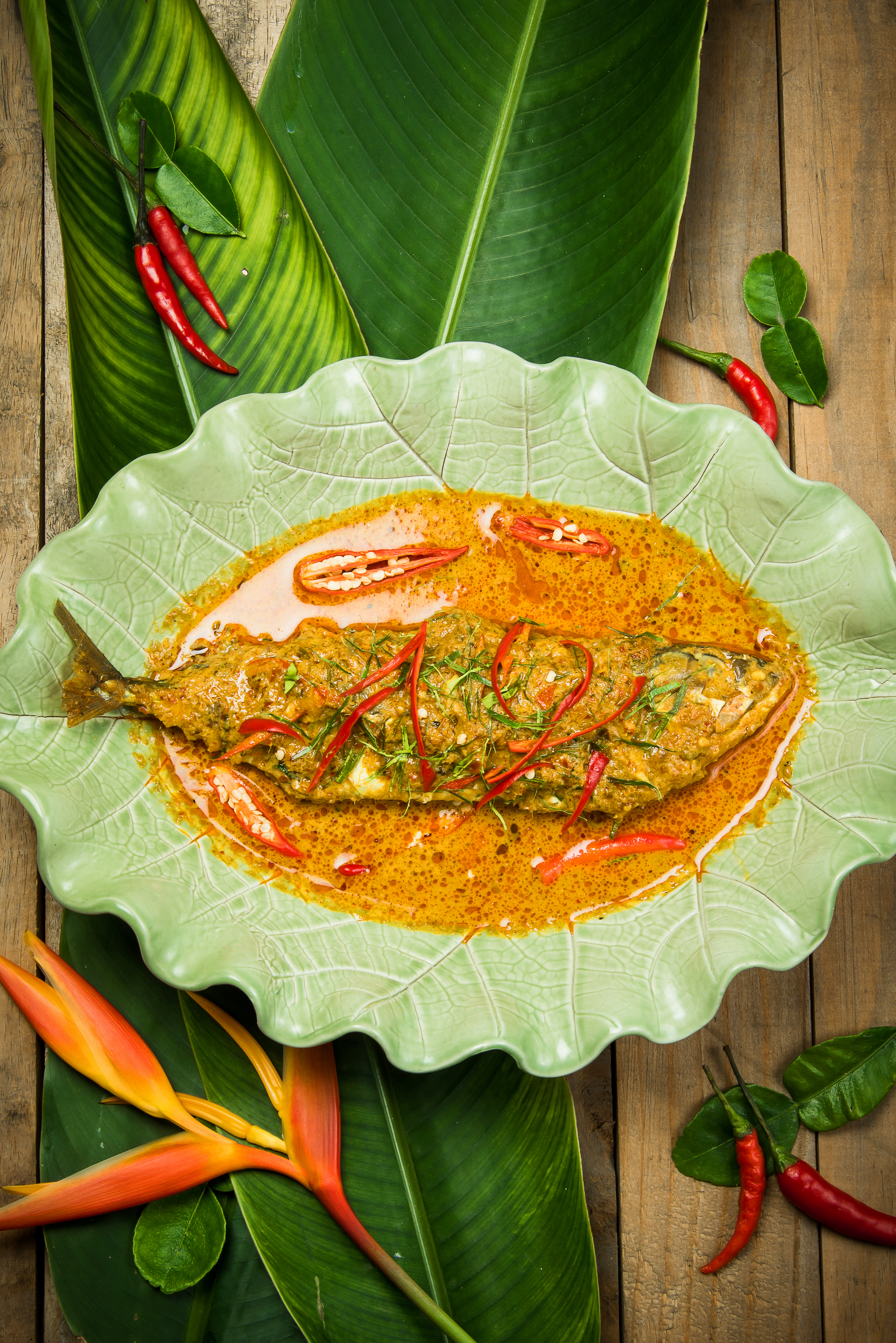 Overhead flat-lay of all ingredients for Fragrant Cambodian Fish Amok with Lemongrass laid out on a kitchen surface.