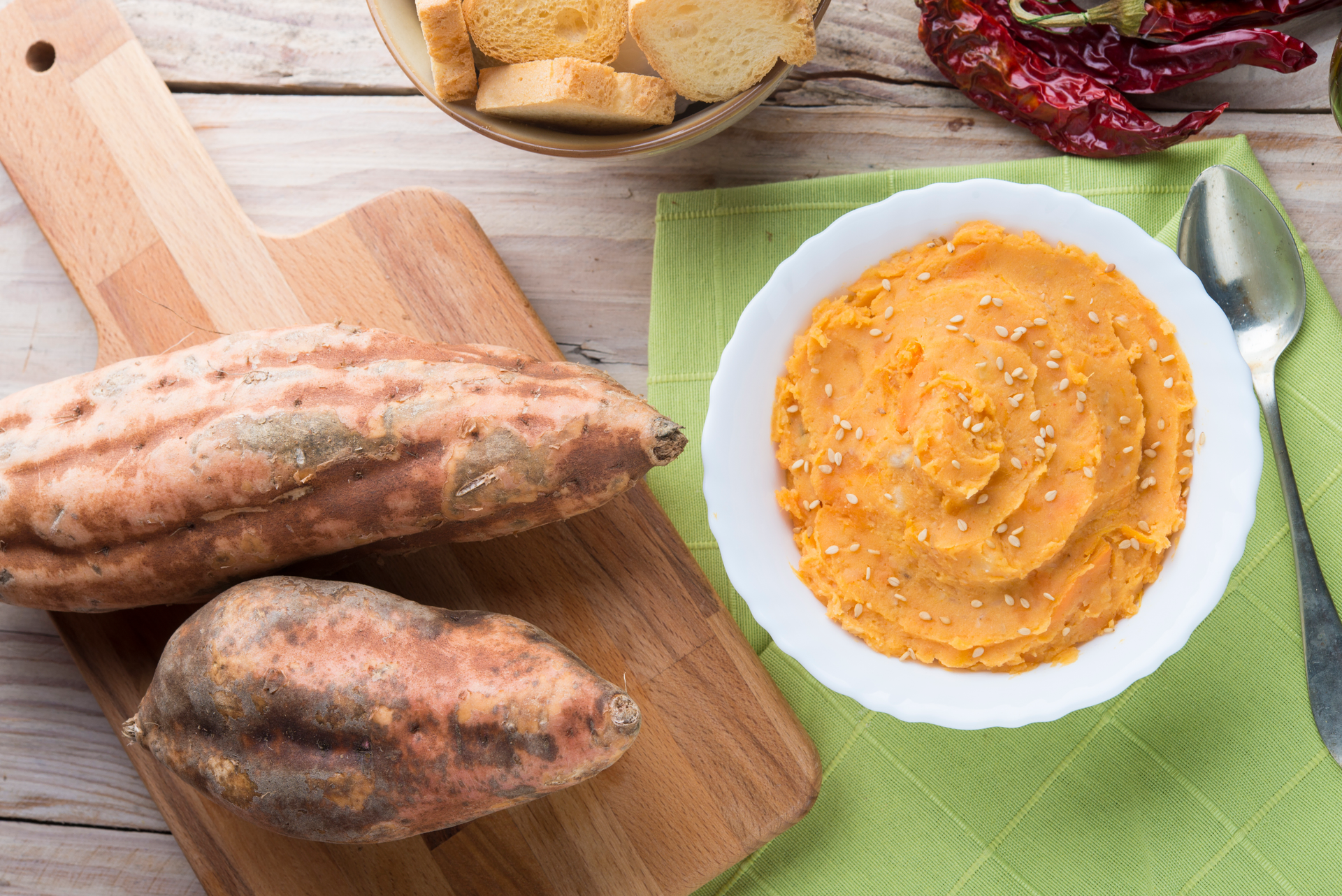 Overhead flat-lay of all ingredients for Fragrant Ethiopian Berbere-Spiced Sweet Potato Mash laid out on a kitchen surface.