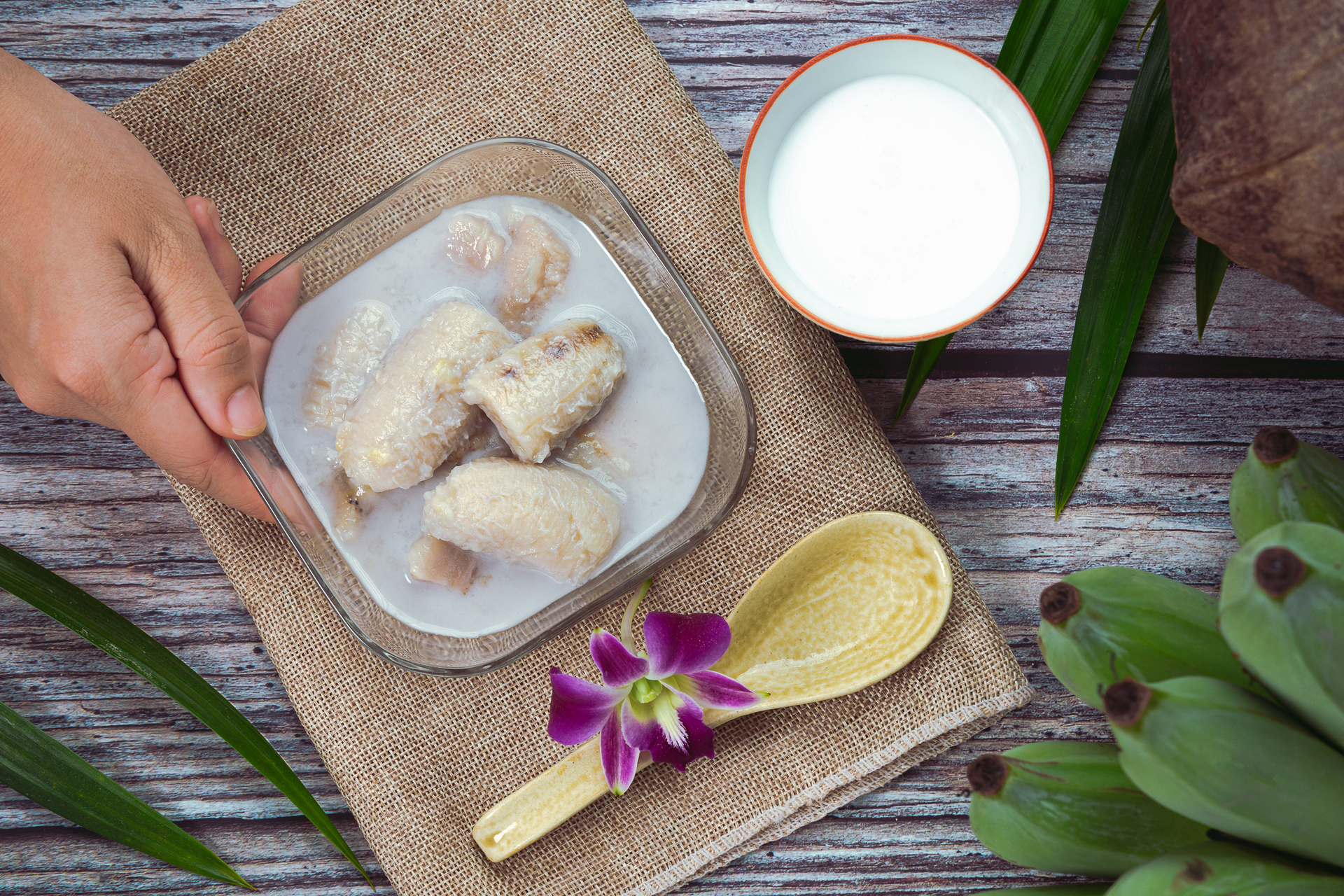 Overhead flat-lay of all ingredients for Fragrant Filipino Laing with Taro Leaves and Coconut Milk laid out on a kitchen surface.