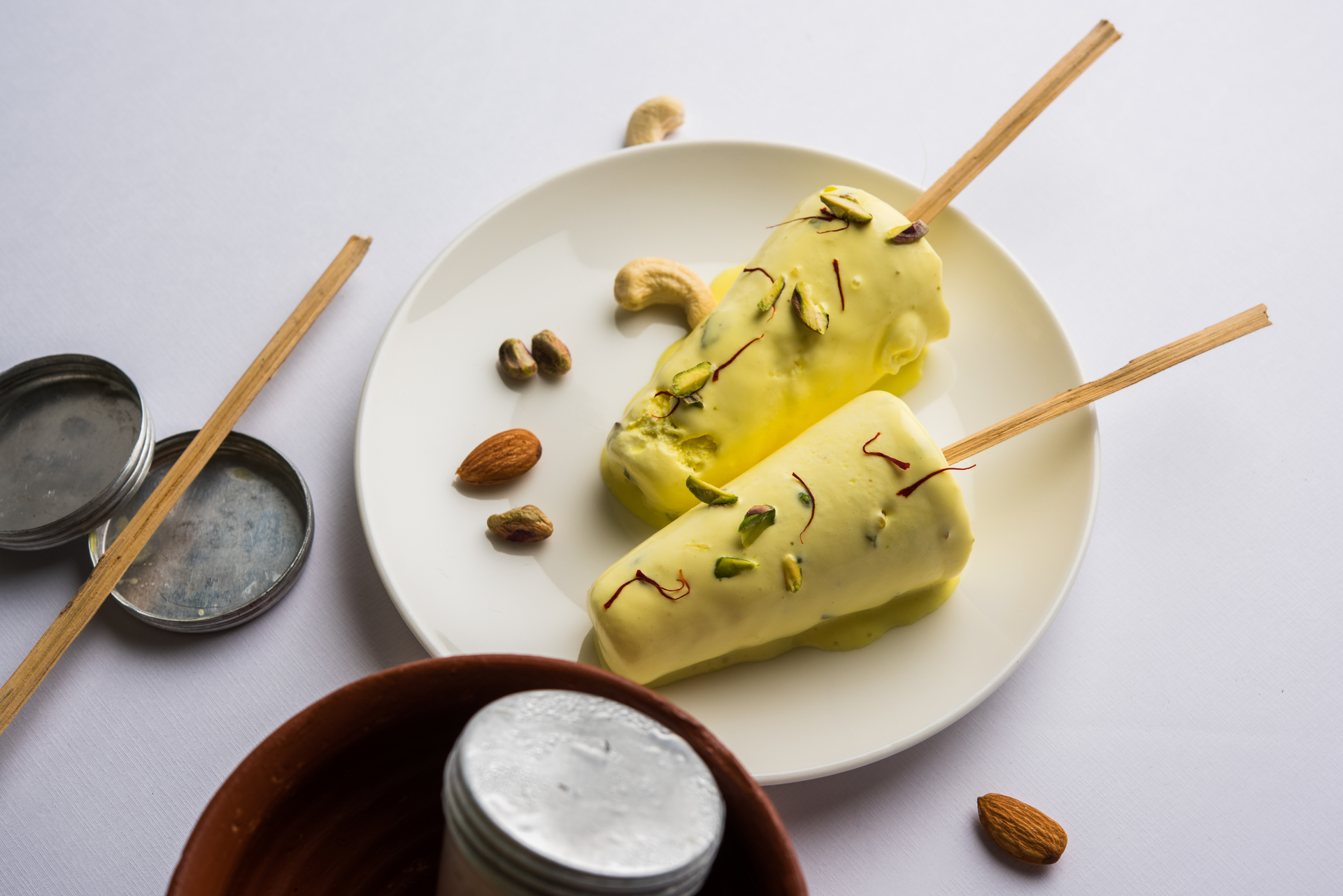 Overhead flat-lay of all ingredients for Fragrant Indian Kesar Kulfi with Saffron Threads laid out on a kitchen surface.