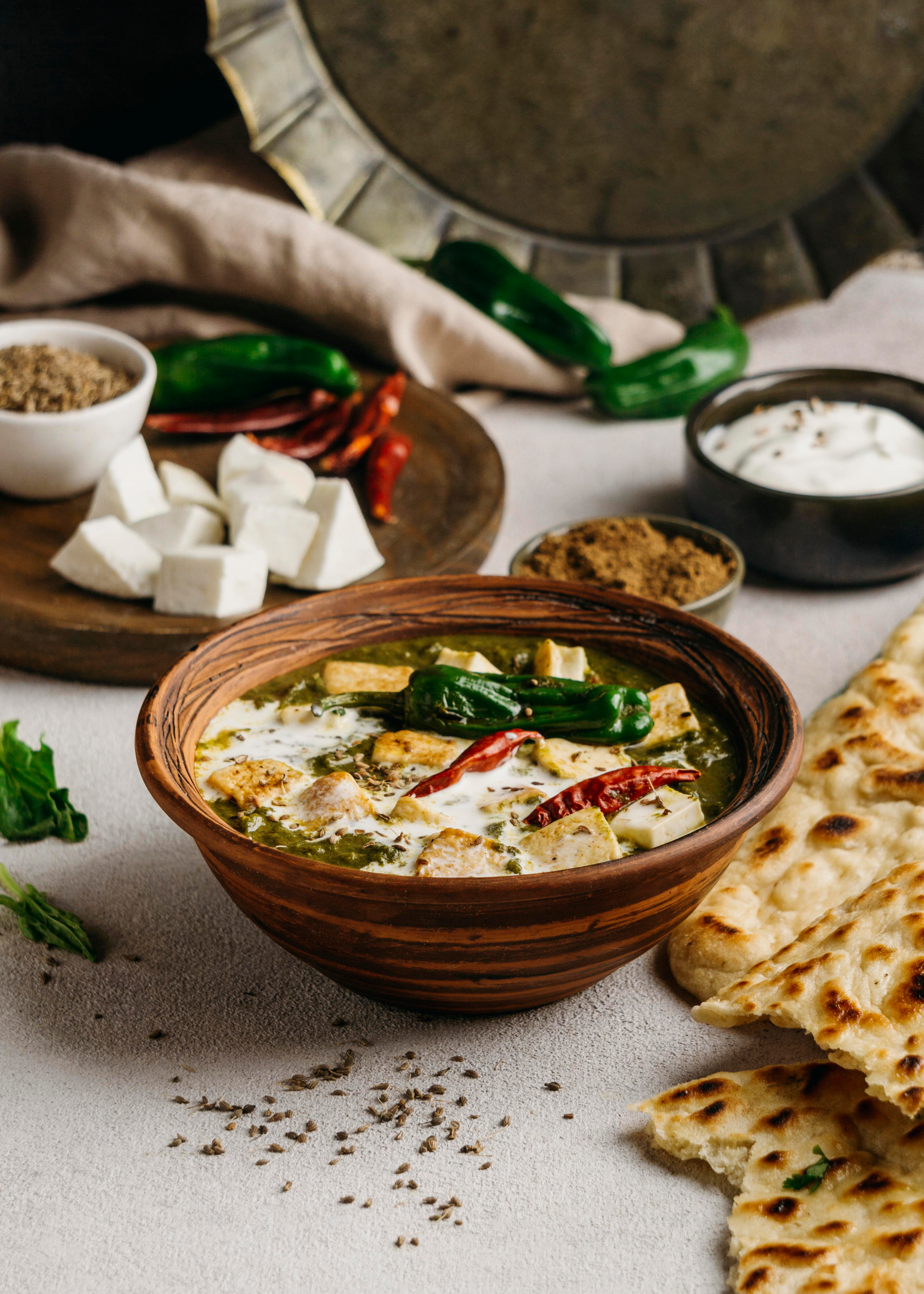 Overhead flat-lay of all ingredients for Fragrant Indian Paneer Bhurji with Cilantro and Tomato laid out on a kitchen surface.