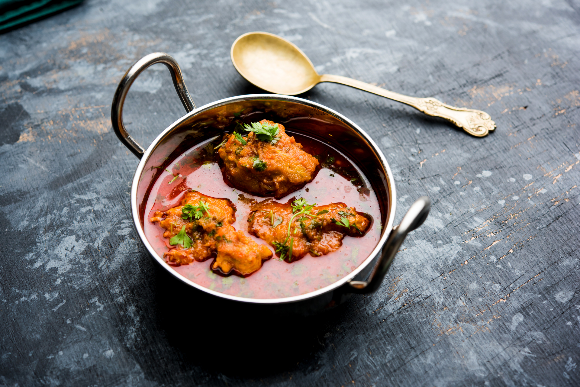 Overhead flat-lay of all ingredients for Fragrant Indian Sambar with Drumsticks and Tamarind laid out on a kitchen surface.