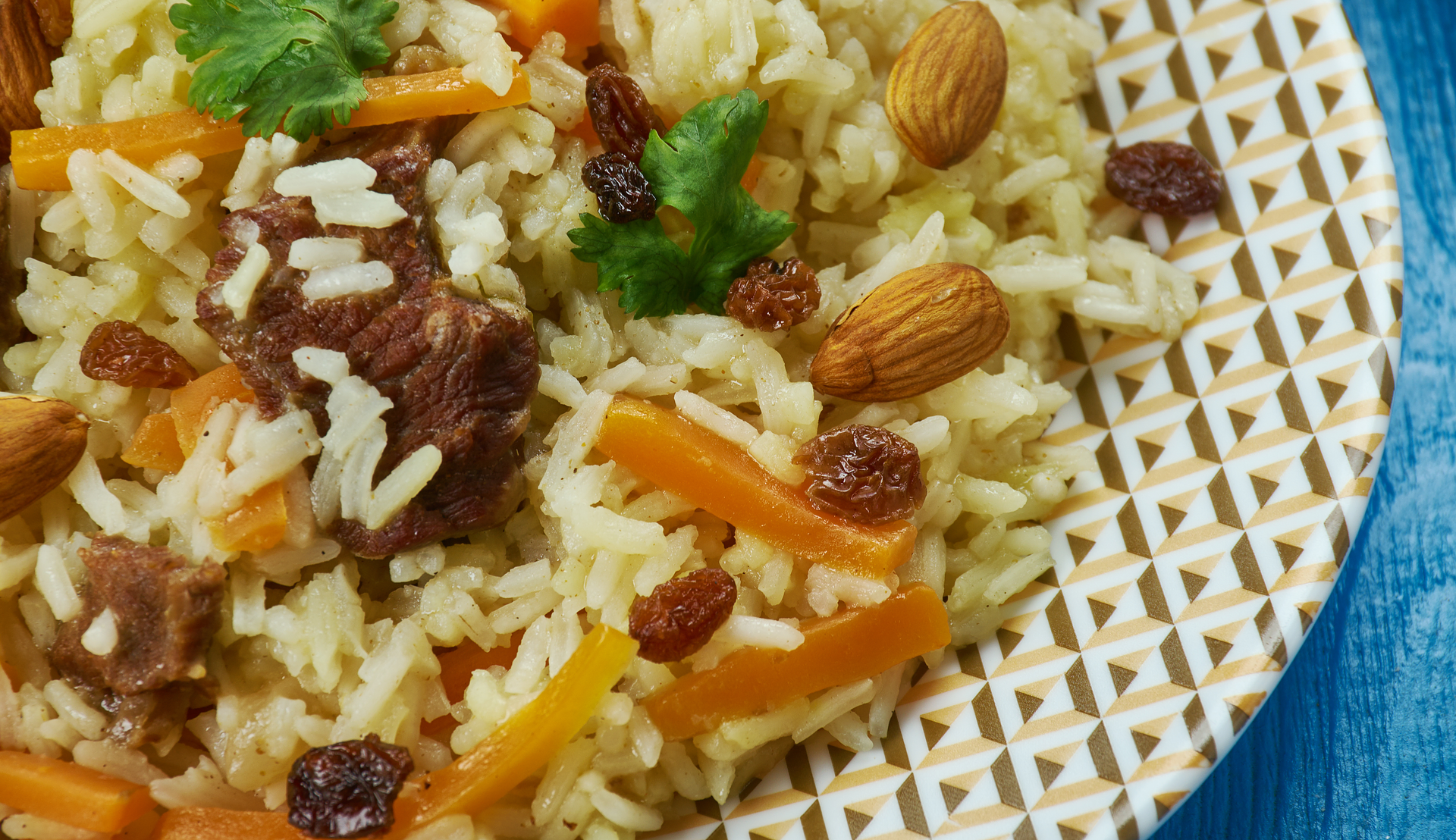 Overhead flat-lay of all ingredients for Fragrant Kenyan Pilau with Cumin-Infused Beef and Sweet Plantains laid out on a kitchen surface.